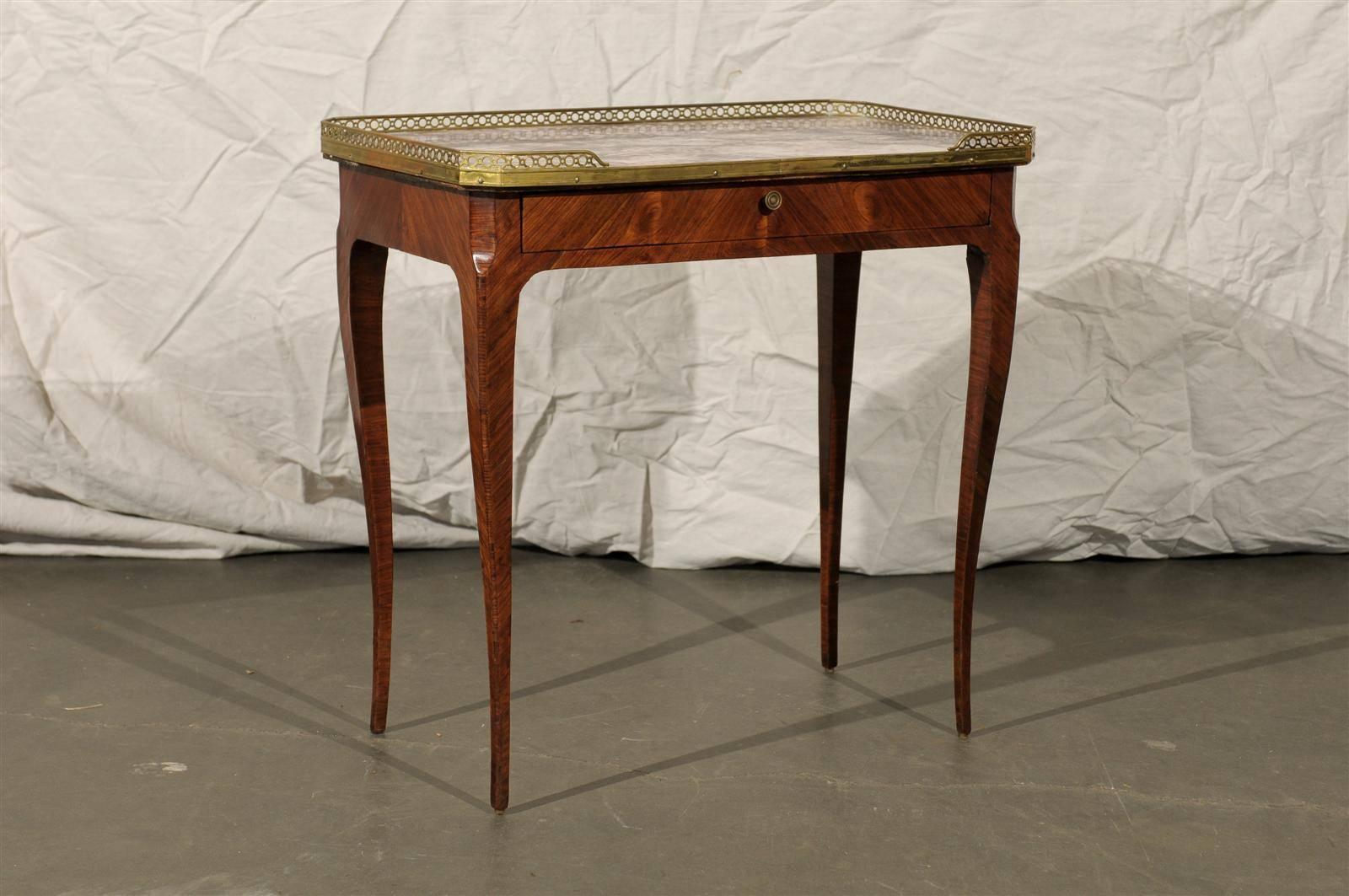 20th century Louis XV style marble-top kingswood table with brass gallery.