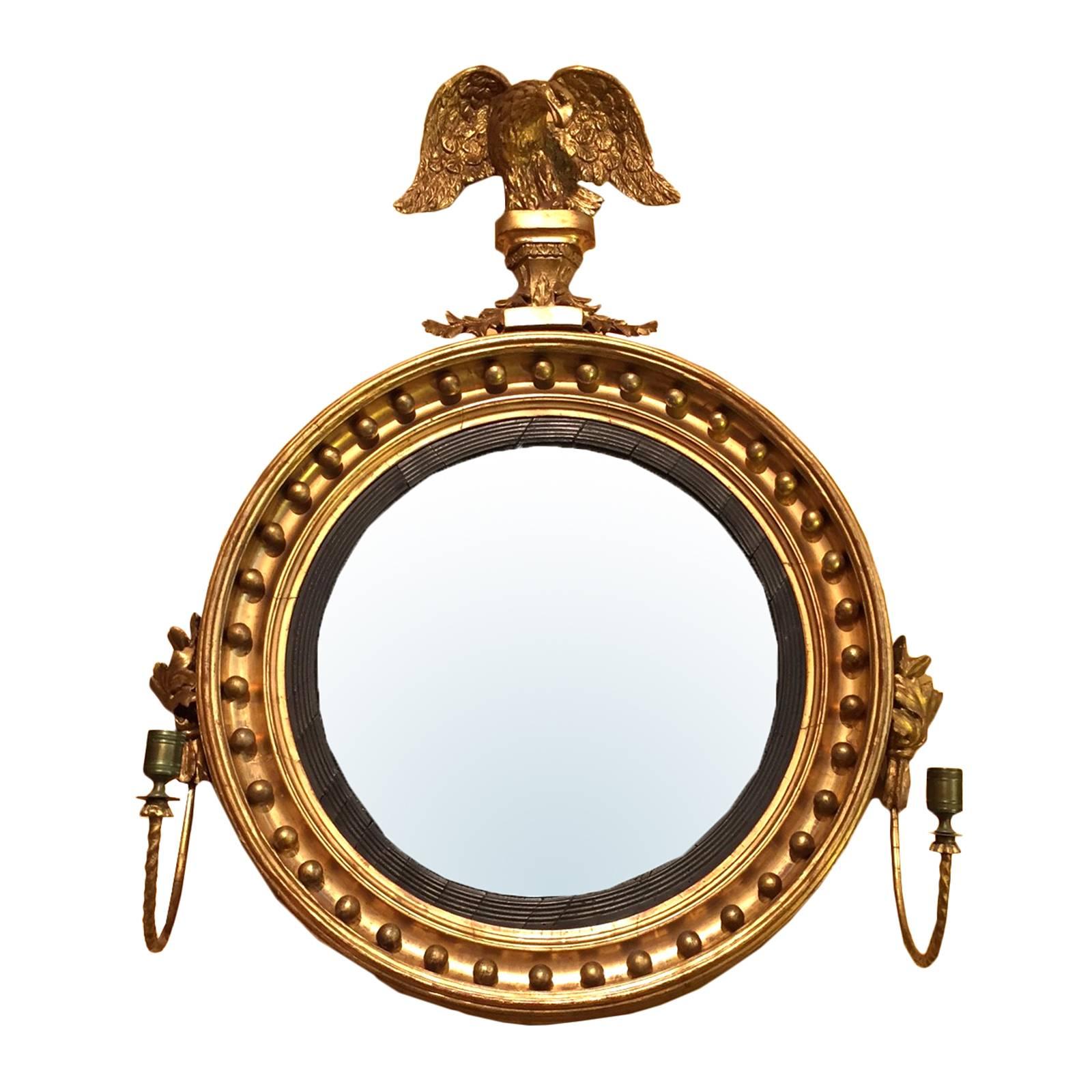 19th century American giltwood convex mirror with eagle and sconce, incredible scale.