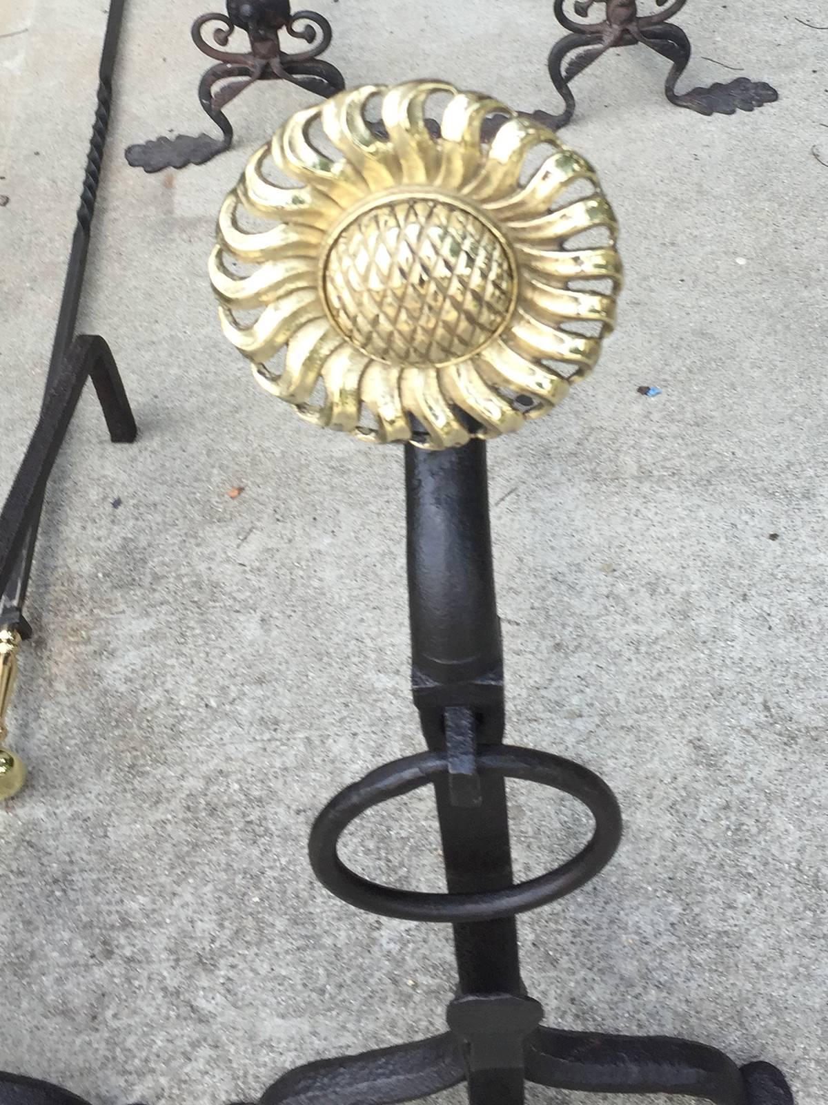 Large turn of the century iron and brass sunflower andirons.