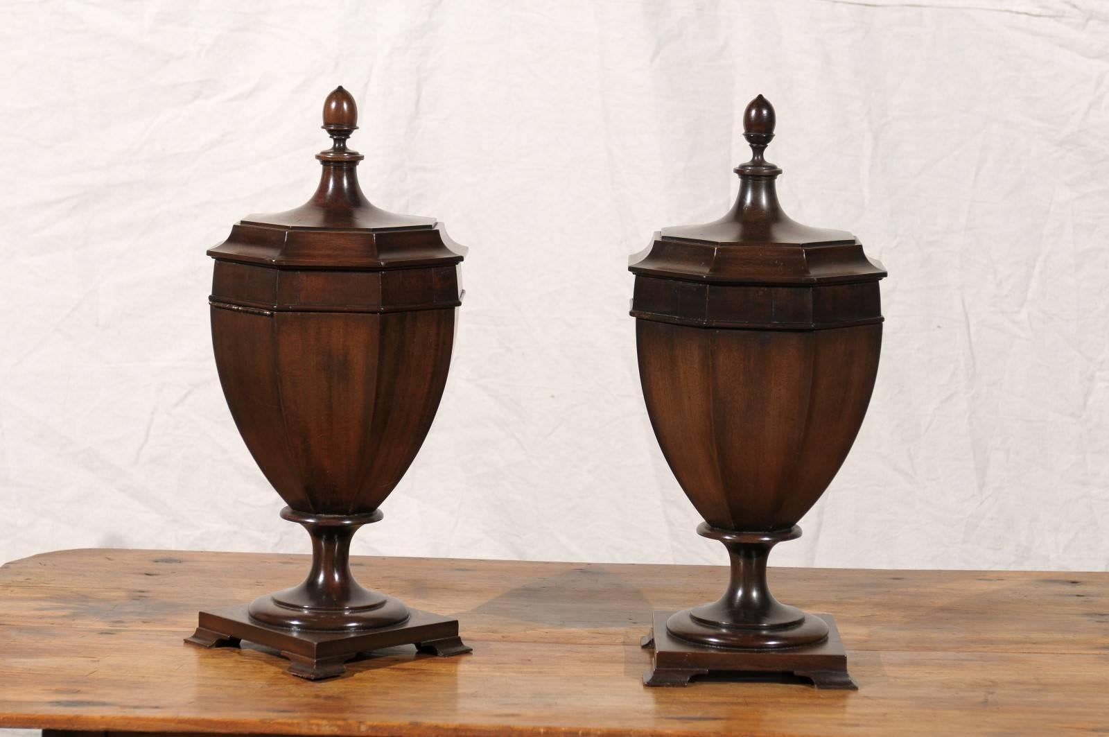 19th-20th century Georgian style mahogany knife urns with octagonal lids.
