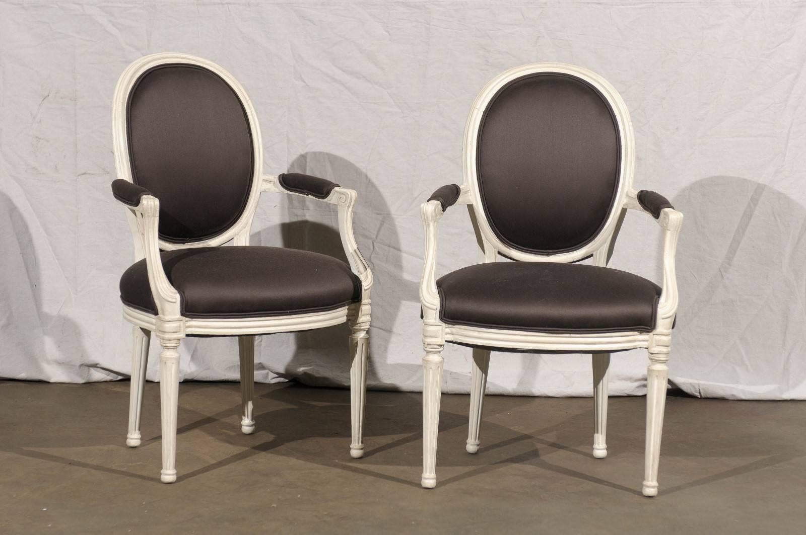 Pair of 20th century painted Louis XVI style armchairs.