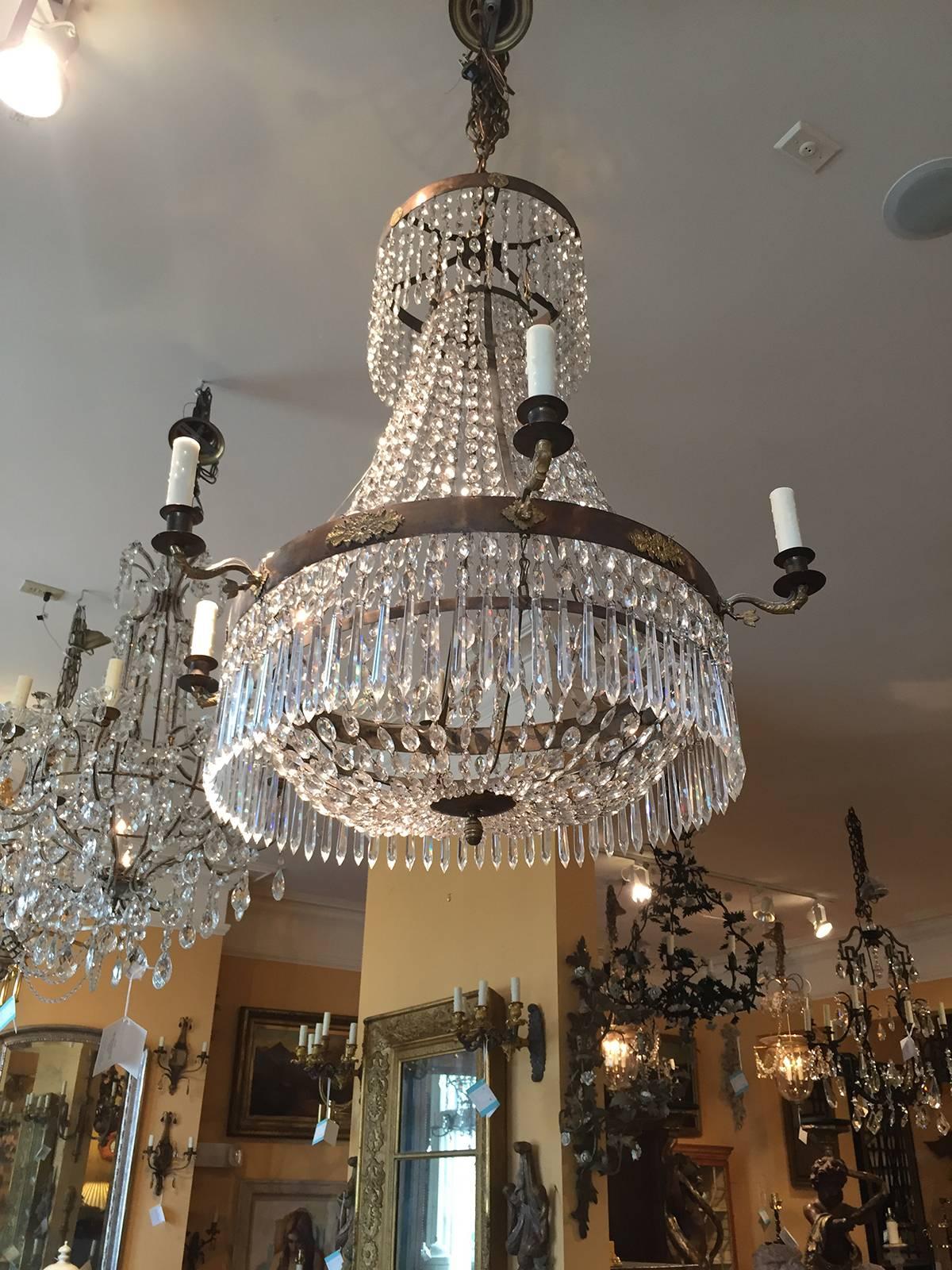 English Regency crystal and bronze chandelier, elegant form, featuring casting, candle arms are dolphin form with tails, Regency detailing, circa 1840.