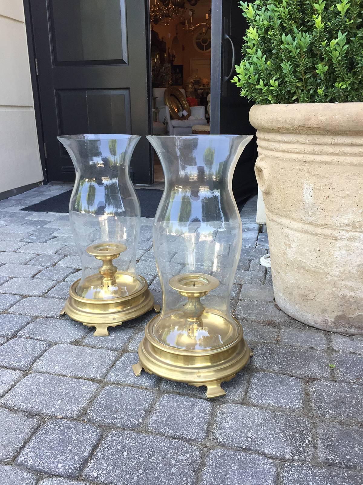 Pair of circa 1970s brass hurricane stands with globe and candleholder, attributed to Chapman.