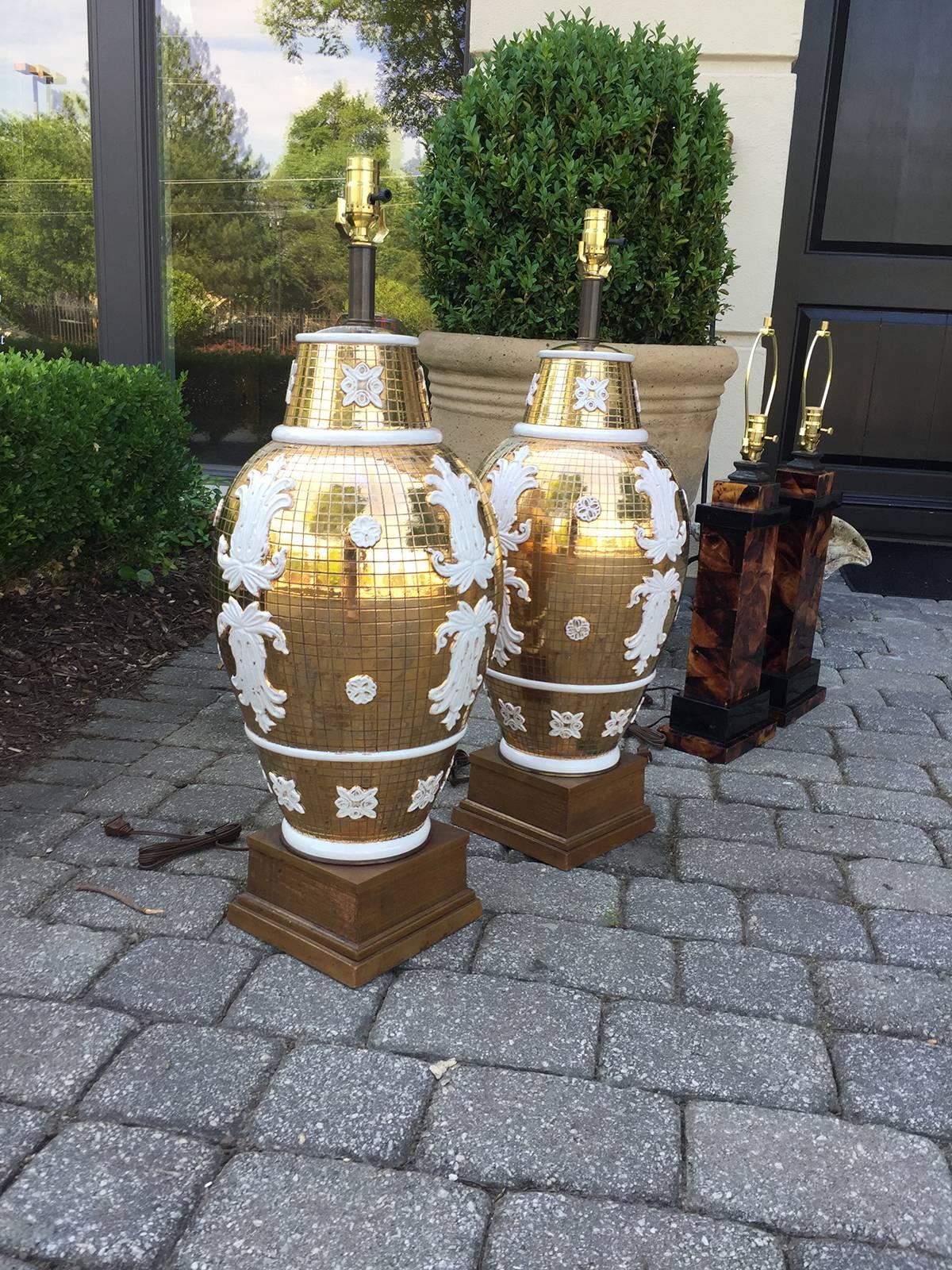 Pair of Mid-Century Italian ceramic lamps by Ugo Zaccagnini for Marboro, handcrafted Italian ceramic with metallic gold, scored body and white- glazed appliques, giltwood bases with brass necks.