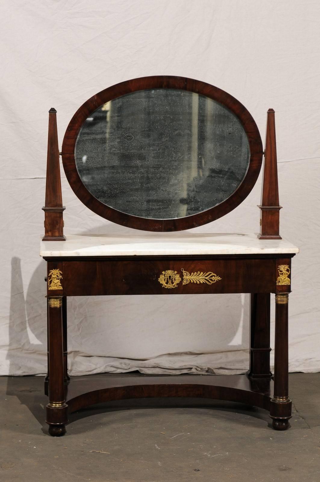 19th century French Empire flame mahogany marble top dressing table with oval mirror and one drawer.