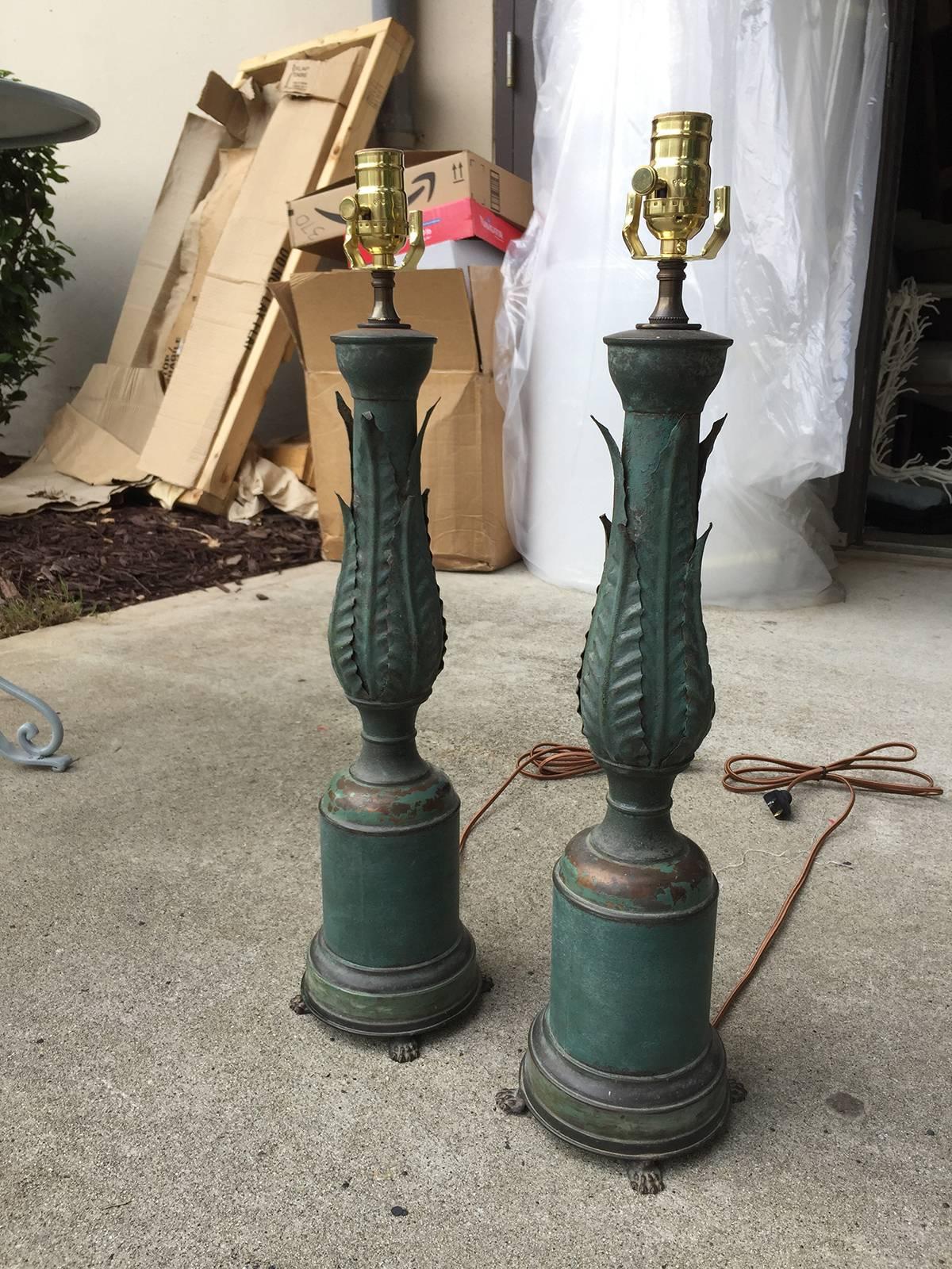 Pair of 1920s neoclassical tole lamps with acanthus leaves and lion paw feet, incredible form.