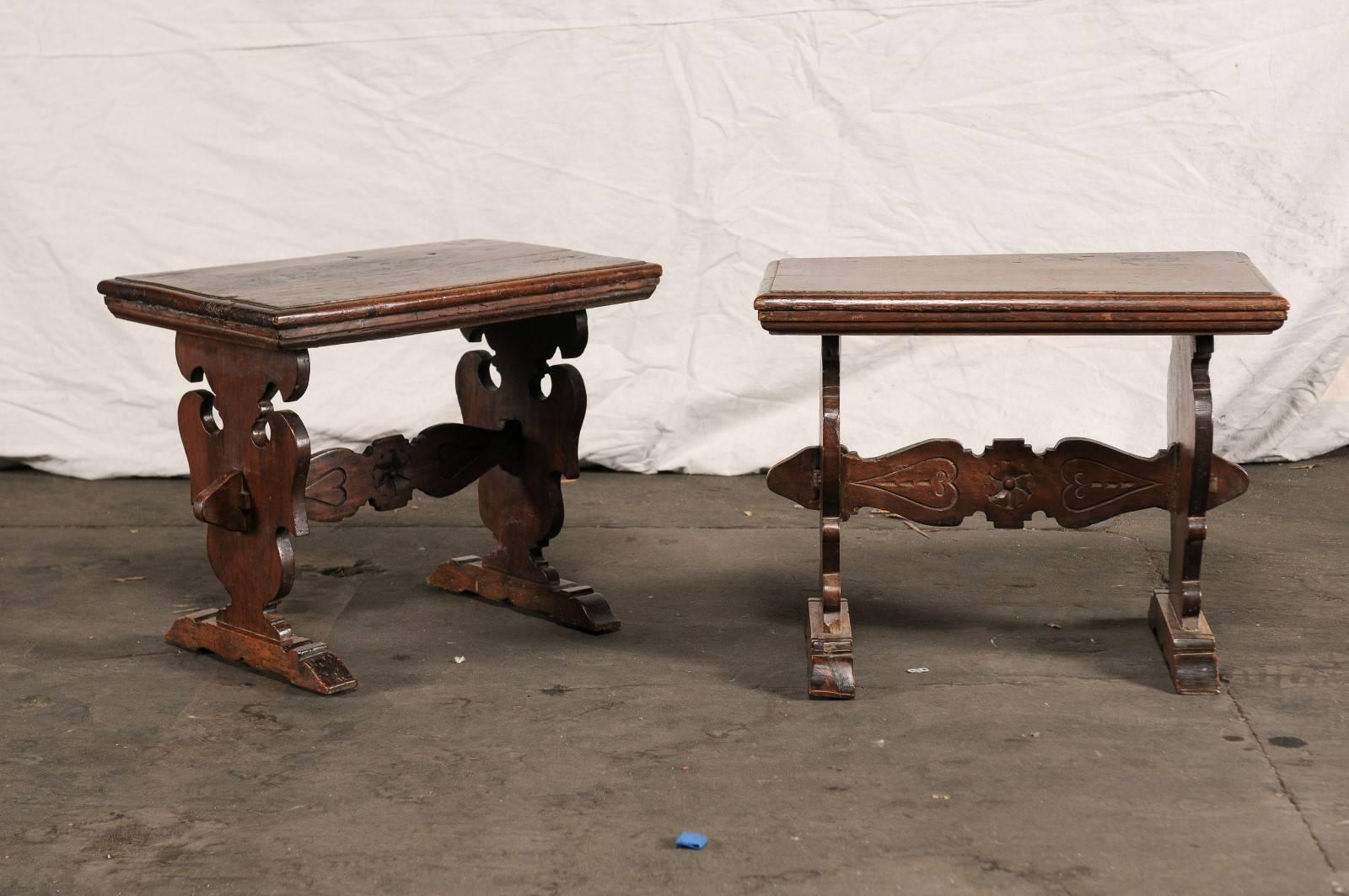 Pair of 20th century walnut continental side tables on carved trestle leg base.