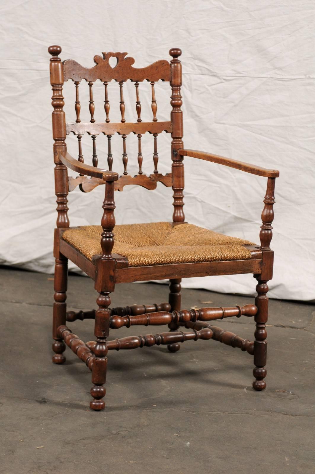 19th century continental Provençal armchair, spindle back, rush seat, turned stretchers and legs. Measures: Seat height 17