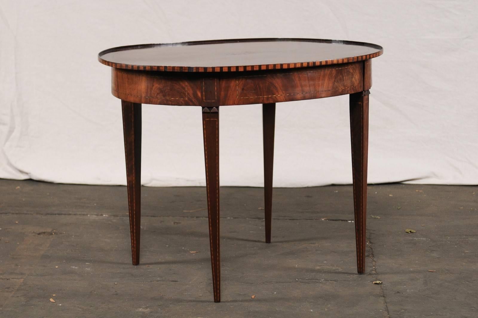 19th century neoclassical inlaid mahogany oval table, great patina and color.
