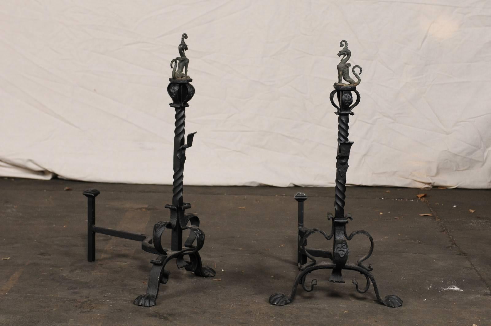 Pair of early 20th century American Continental iron andirons, griffon finial.