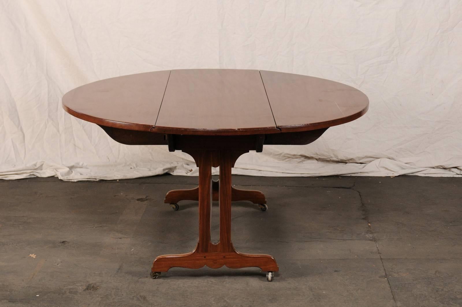 Late 19th Century Drop-Leaf Table, Trestle Form Base with Casters For Sale 1