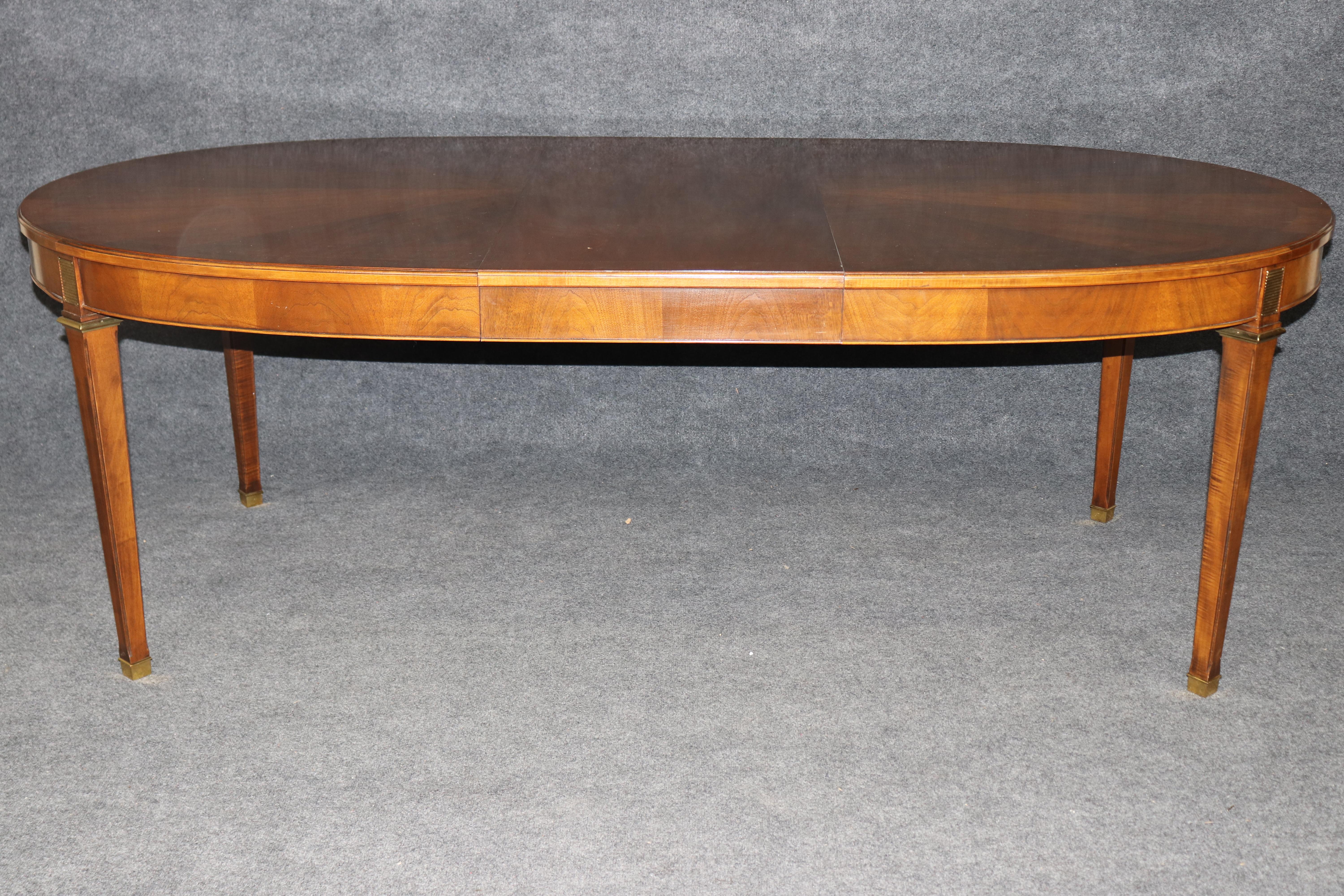 Dimensions - H: 29 1/4 in  W (Closed): 66 in D: 46 in 
W (Open With Both Leaves in): 106 in
W (Each Leaf): 20 in

This magnificent dining table exemplifies the refined elegance of French Louis XVI design, executed in the distinguished manner of the