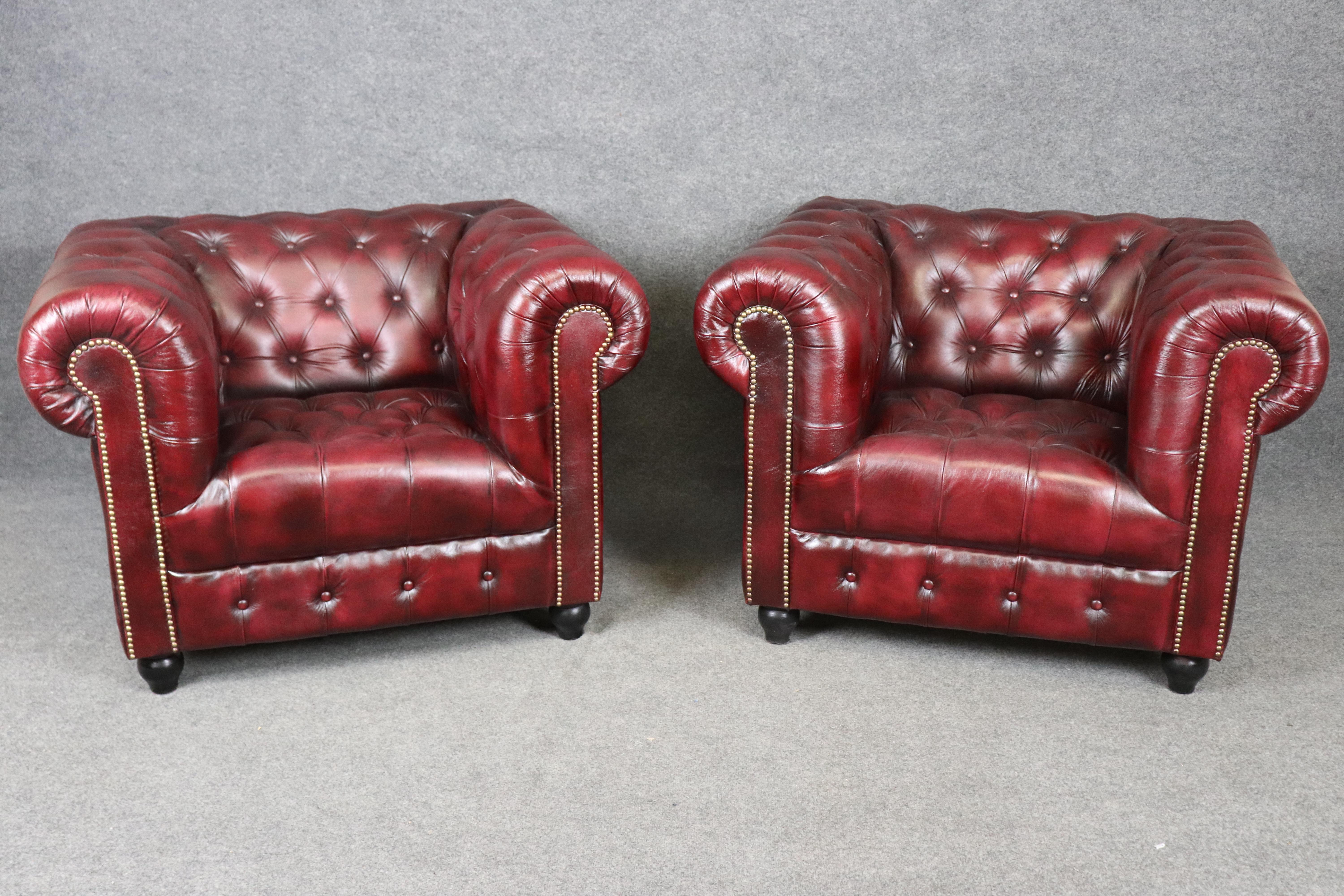 Dimensions - H : 30 1/2 in  L : 43 1/4 in D : 37 3/4 in SH : 18 in 
Profondeur du siège : 21 1/4 in 

Élevez votre intérieur avec cette paire sophistiquée de fauteuils club vintage de style Chesterfield, magistralement recouverts de cuir bordeaux
