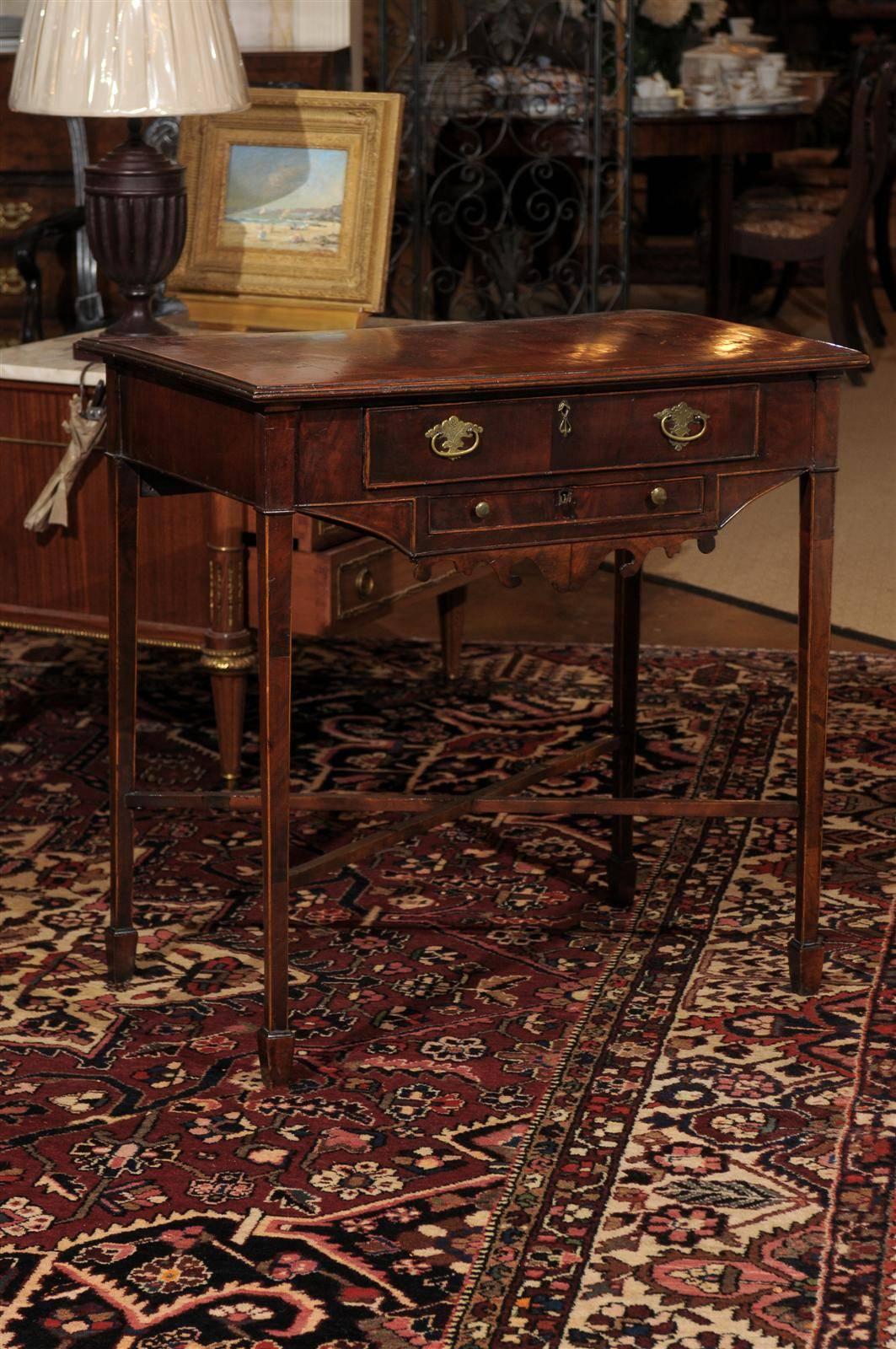 A beautiful period George ll side table with satinwood inlay. A scalloped apron underneath a small drawer is supported by tapered legs with X-stretcher.