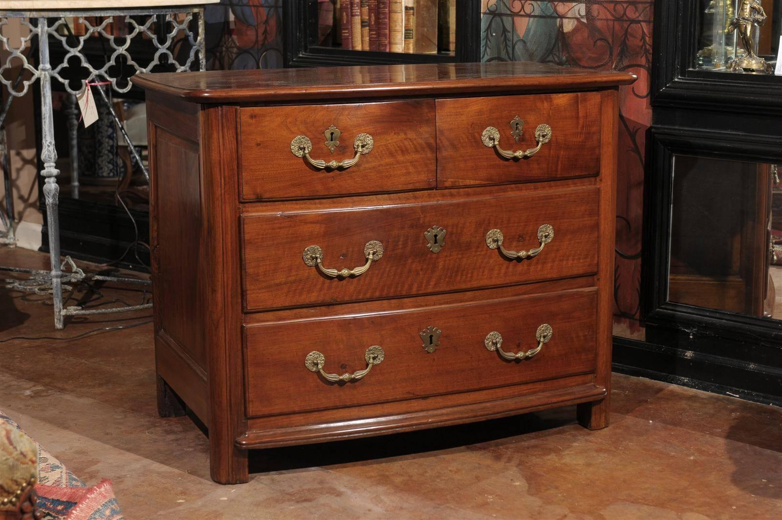 A beautiful handcrafted chest of drawers (late 1700's) with wooden pegs visible on the top. 
Molded edge and slightly bow front case with configuration of drawers on molded feet. All original bronze hardware and escutcheons with original keys.