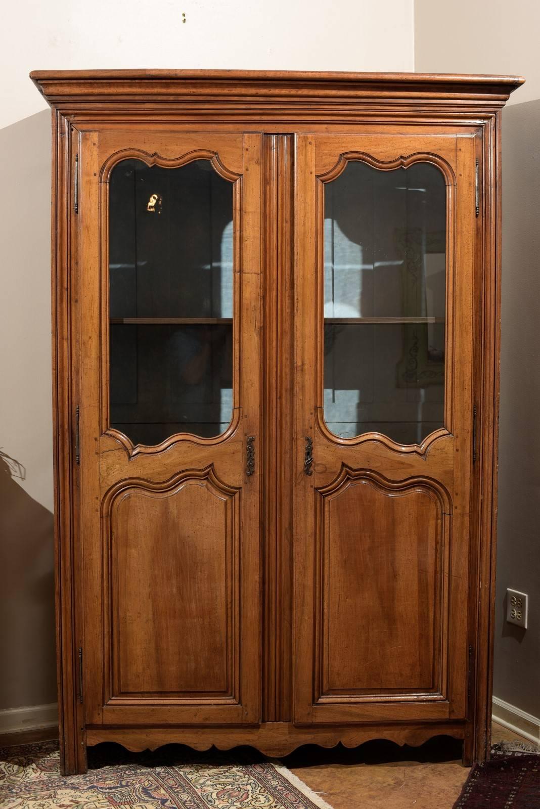 A tall antique Vitrine which is lovely for displaying items. There are two doors with the upper being glass. Two drawers are inside which possibly were added later.
The inside is painted a light blue and has brackets and shelving. Original locks