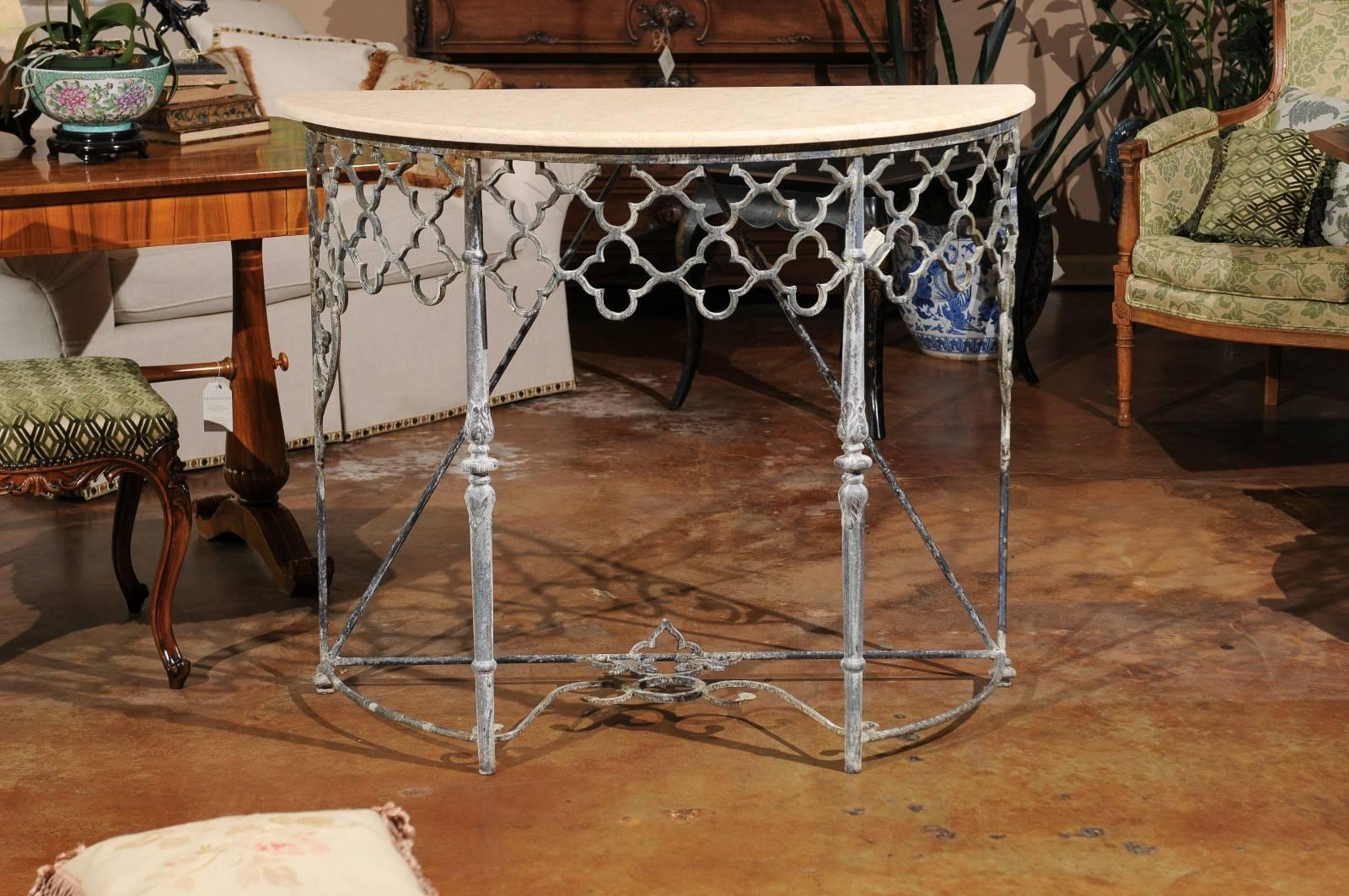 These base of these demilune tables is made from old iron which has been hand-forged. The top is new limestone.