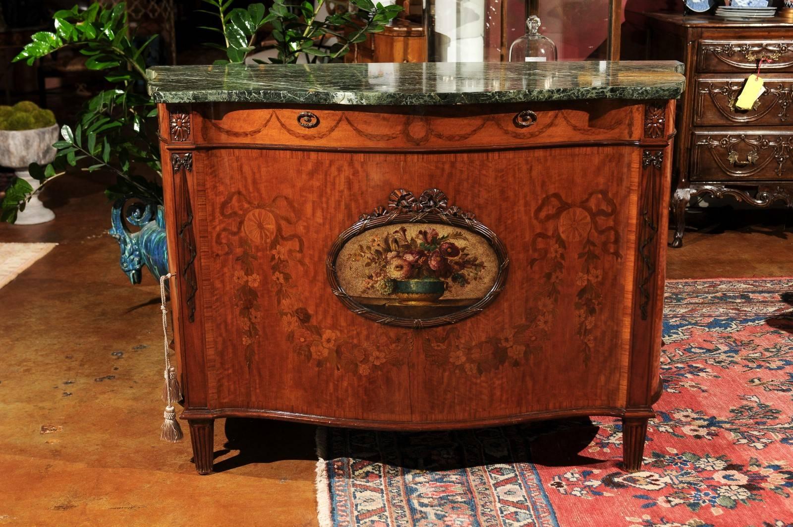 An exquisite Italian buffet with green marble top. Beautiful marquetry inlay of swags and floral design decorate the front and sides. A hand-painted floral design is surrounded by a hands carved framing. Hand-carved detail is on the front as well as