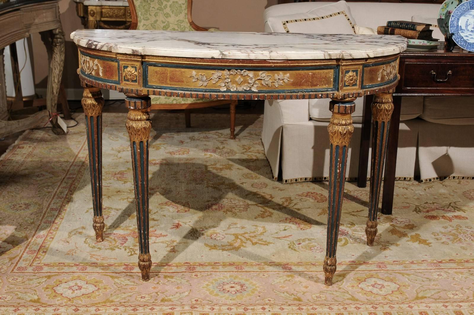 A mid-19th century Louis XVI style carved and painted giltwood console table with D-shaped marble top, molded skirt and fluted tapered legs. Very beautiful!