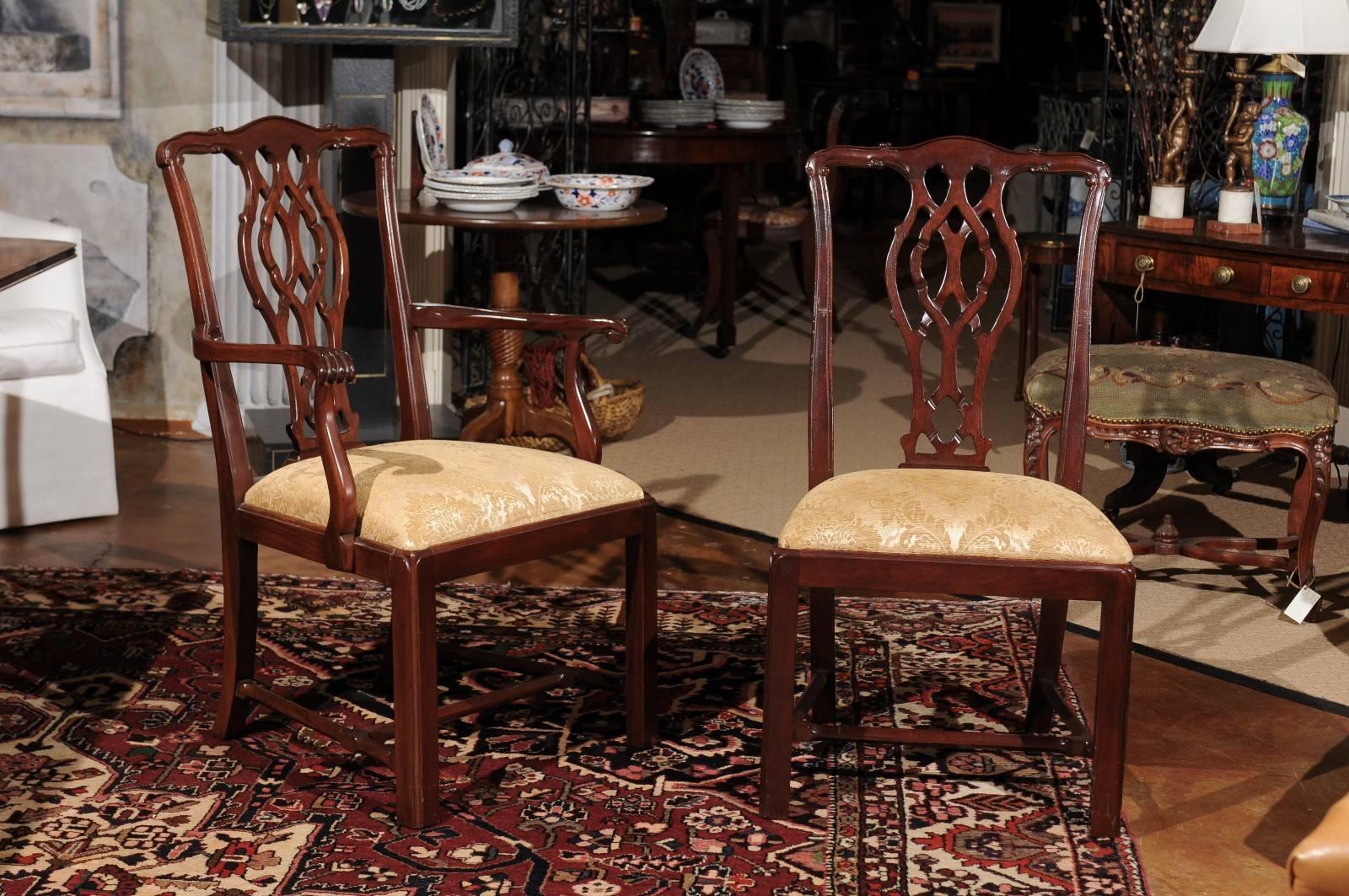Six side and two arm vintage mahogany Chippendale chairs with pierced back splats which is a common Chippendale back. The chair rests on straight front legs and splayed back with an H-stretcher for extra support. The drop in slip seat has a