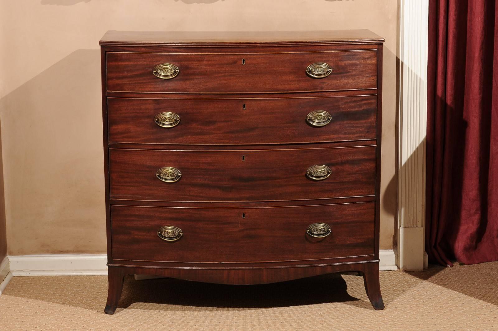 A four-drawer mahogany chest of drawers supported by splayed feet.
Very pretty hardware.