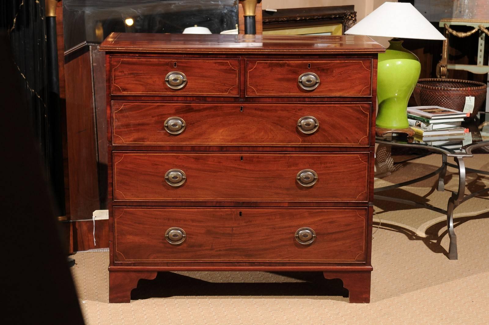 A beautiful Georgian style chest of drawers. Two short drawers over three long drawers each having inlay. The top has satinwood banding and inlay. Help up by bracket feet.