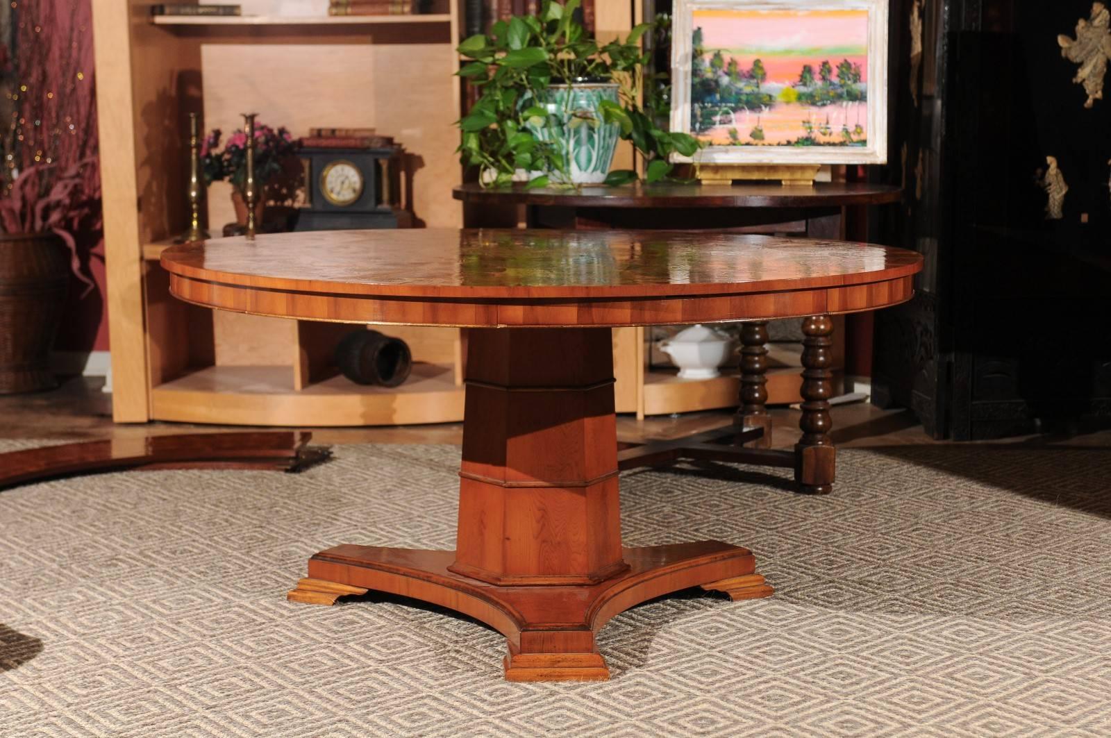 This is a beautiful vintage table. Notice the wonderful design on the top. It also would be a fabulous center table in a large foyer. The table in 60 in. Diameter without the leaves. With the leaves it is 80 in. D. Four drawers surround the table