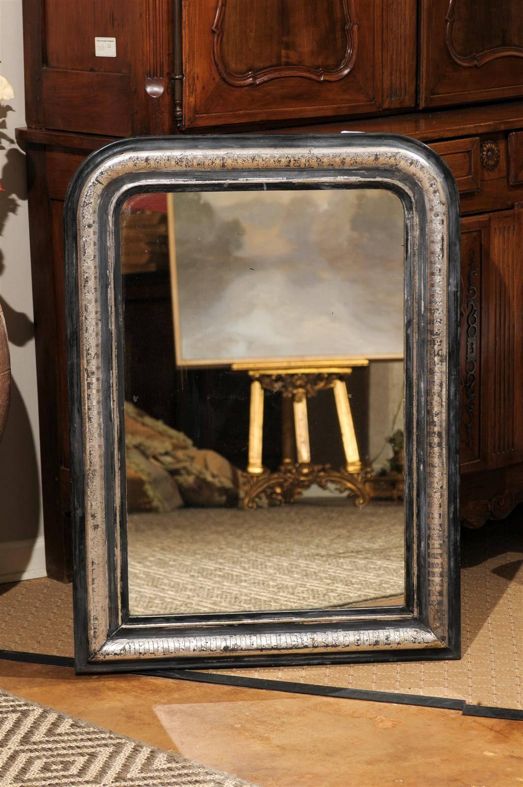 A 19th century silver leaf mirror with black and gray accents.