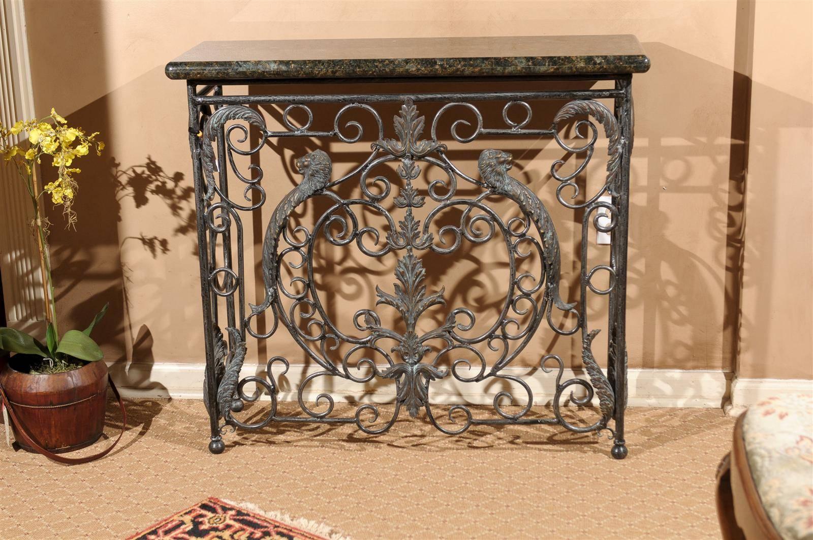 A beautiful piece of granite is supported by a wonderful iron base. The ornate front has two lion heads as the focal point. There is ornamental scrolling down the sides and an open back. It is a nice size which makes it possible to use in a variety