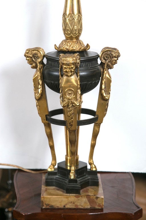 A circa 1900 Caldwell bronze figural lamp with rouge royalle marble base.