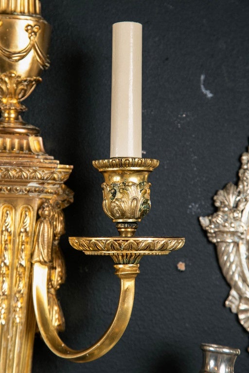 Pair of circa 1920s Caldwell gilt bronze sconces. Neoclassical design. Eight available.