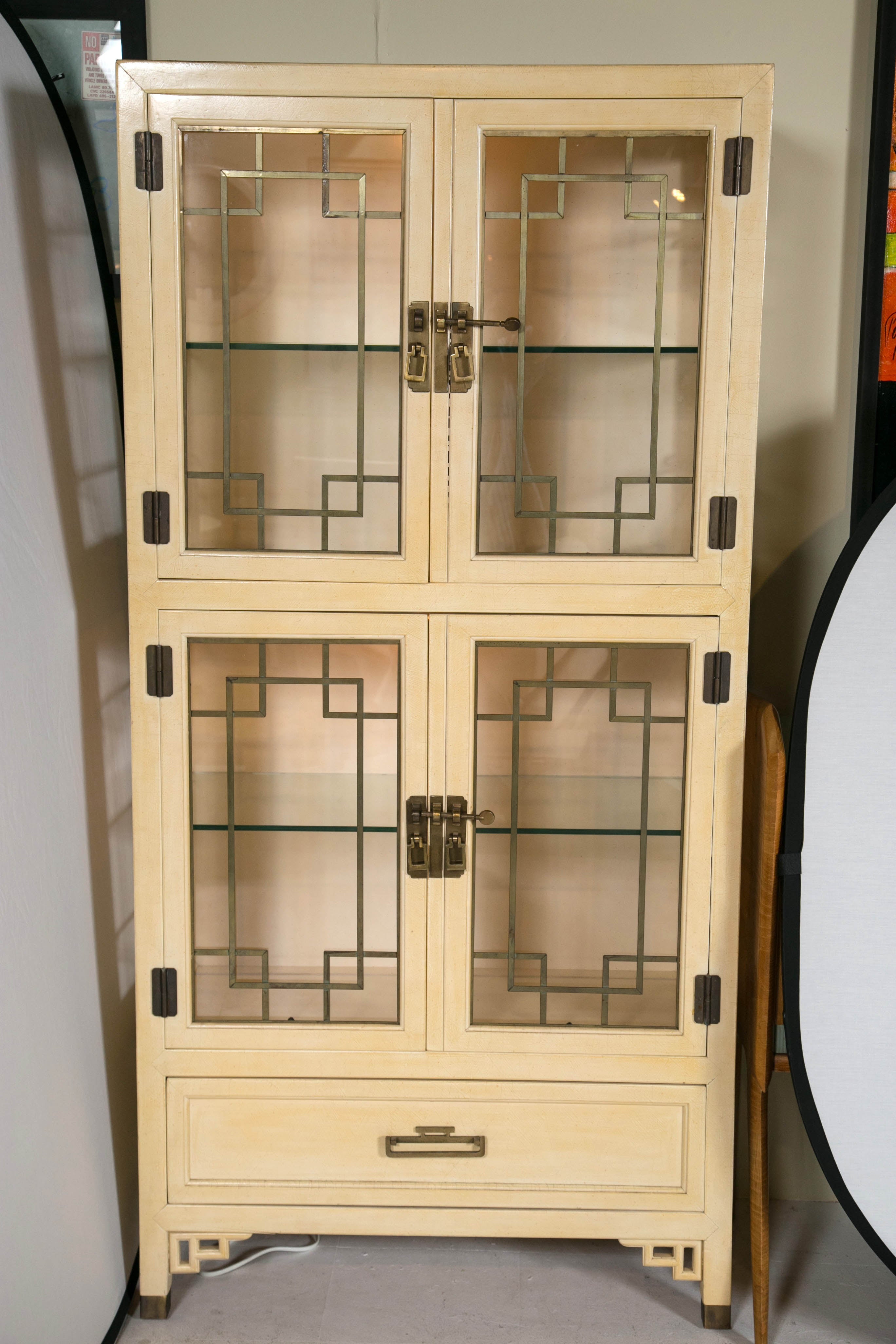 Pair of display cabinets by Century America a Asian styling with brass fittings.