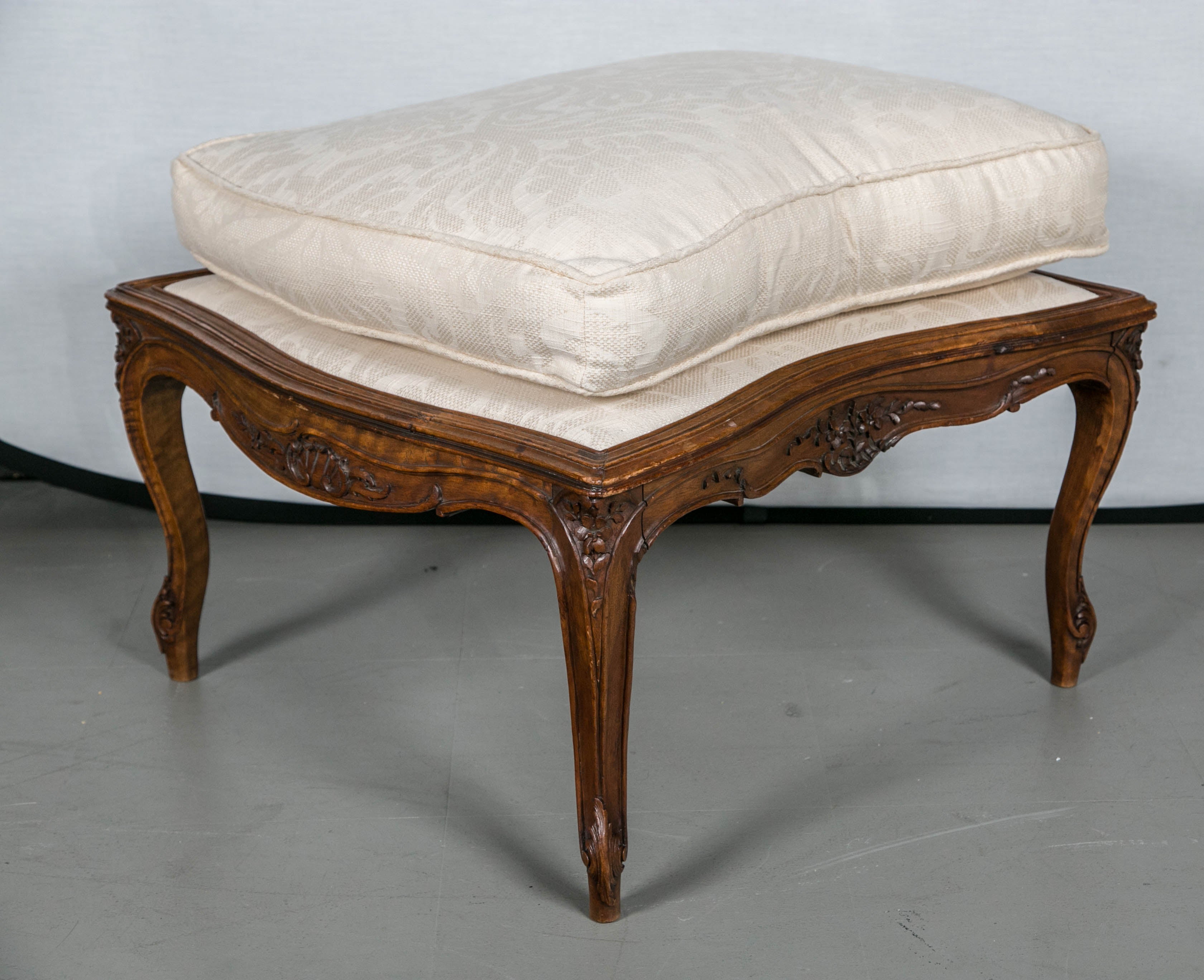 This fabulous chaise lounge circa 1900 newly upholstered in a lovely cream damask. Great carving in frame.