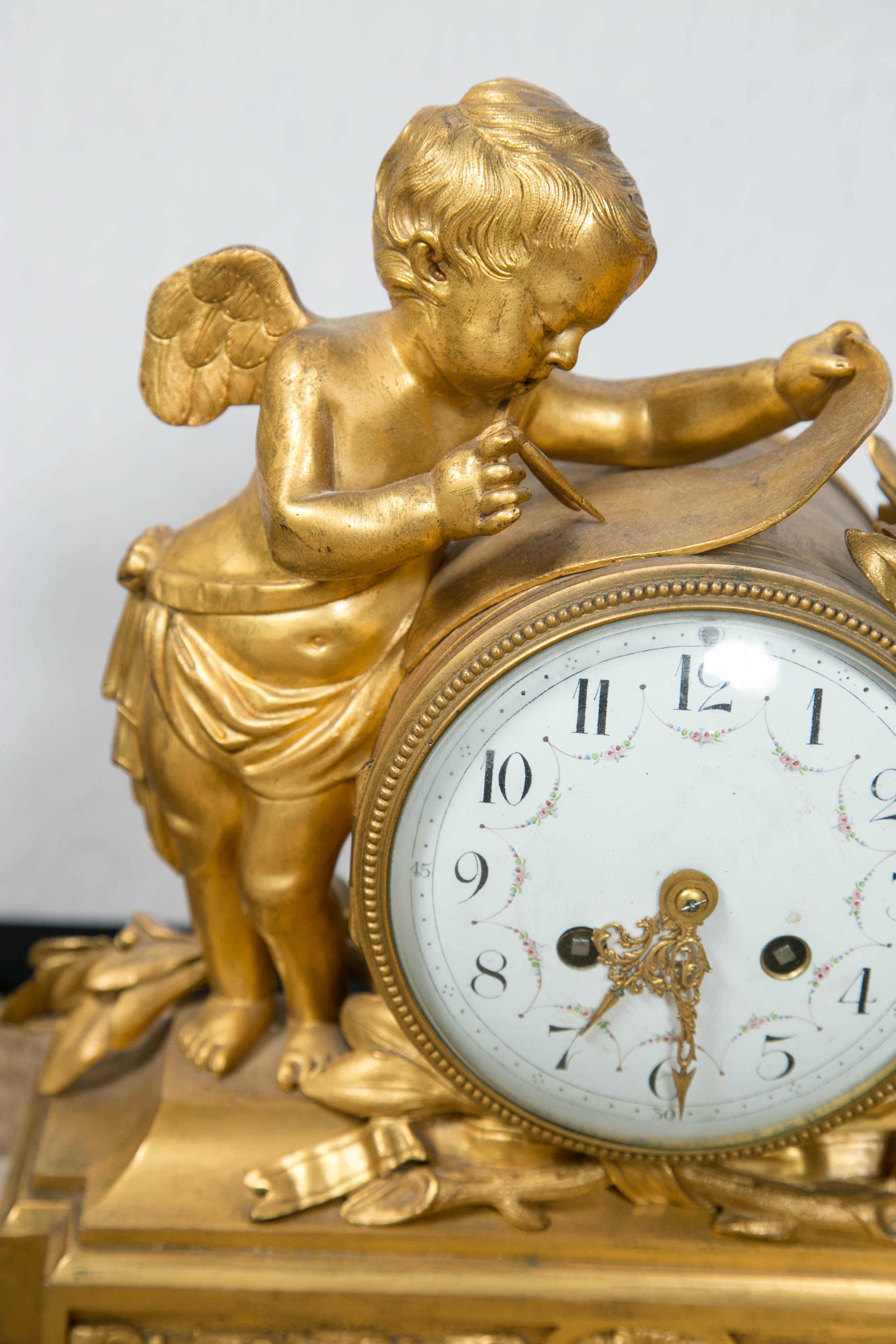 French dore bronze figural clock charming cherub wistfully waiting for time to pass.