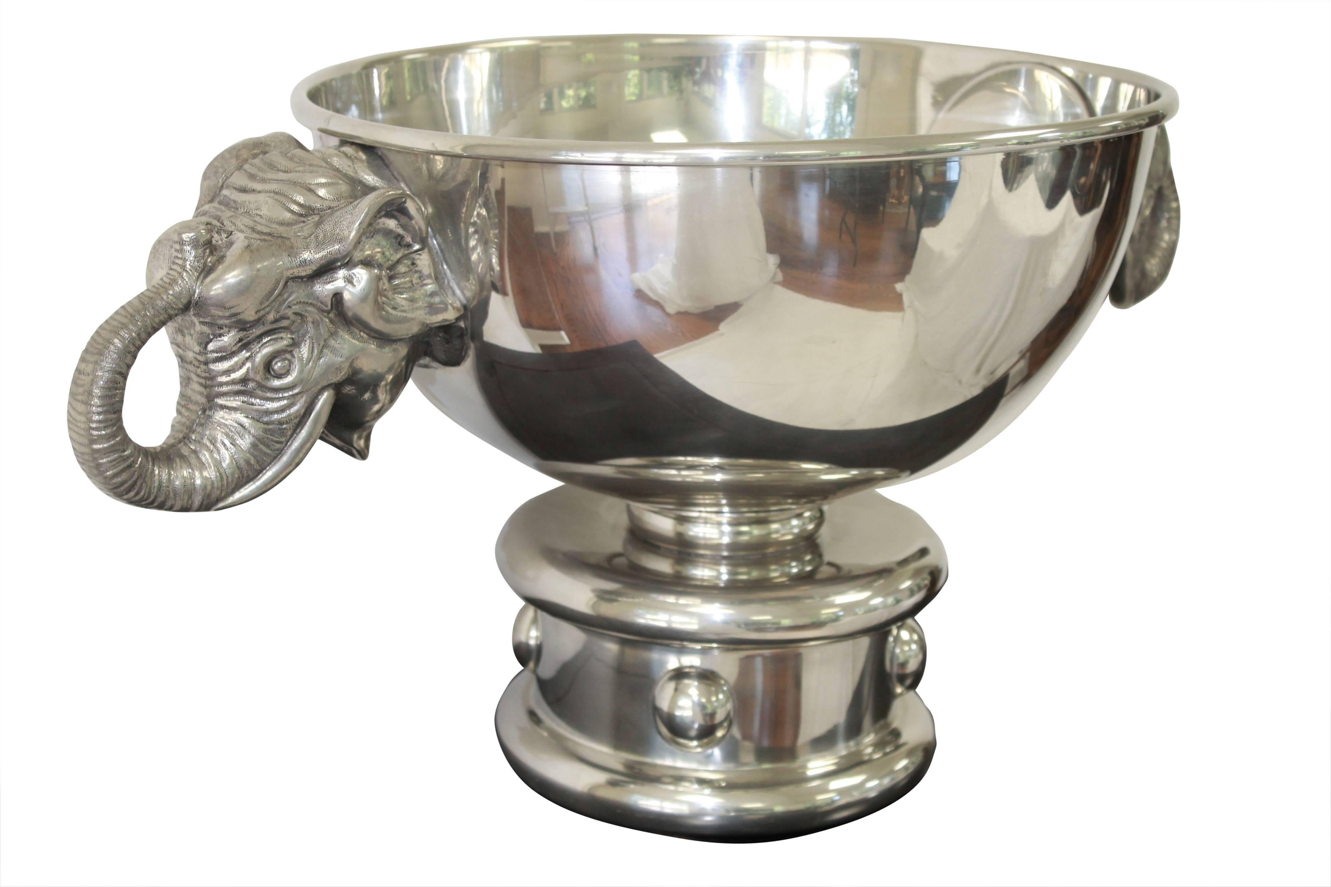 Designed by Figura Piero for Atena, late 20th century. Silver plated pewter champagne cooler in the form of a circus drum supporting the bowl, with elephant mask handles. Stamp to the bottom. Made in Italy. (Identical piece sold; ref. Christies