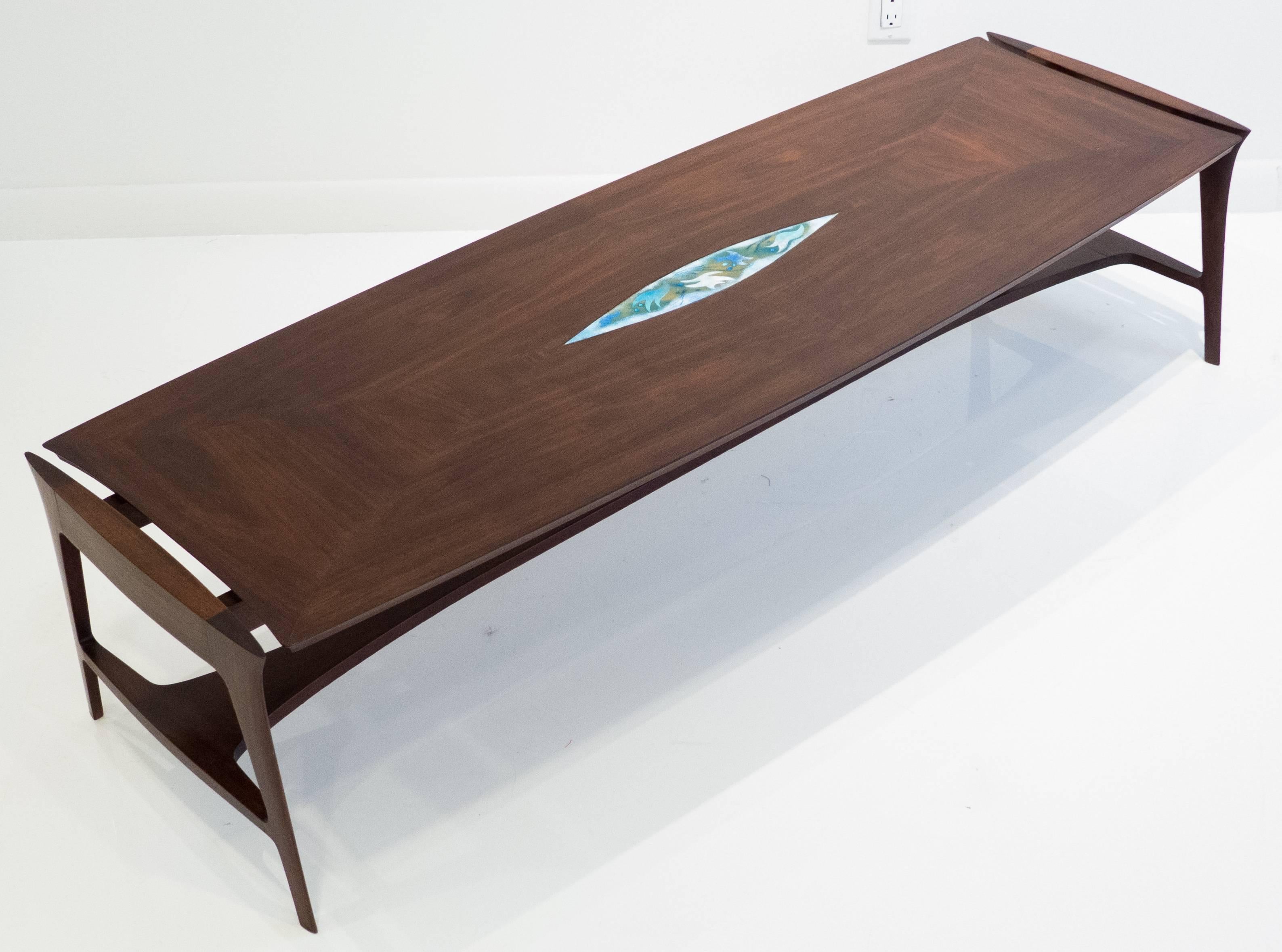 Elongated and stylish cocktail table of walnut with an enamel insert in the centre. The tapering bottom stretcher and side rails are nicely joined and have a European/Jugenstil flair to them, as well as an architectural presence evoking perhaps a