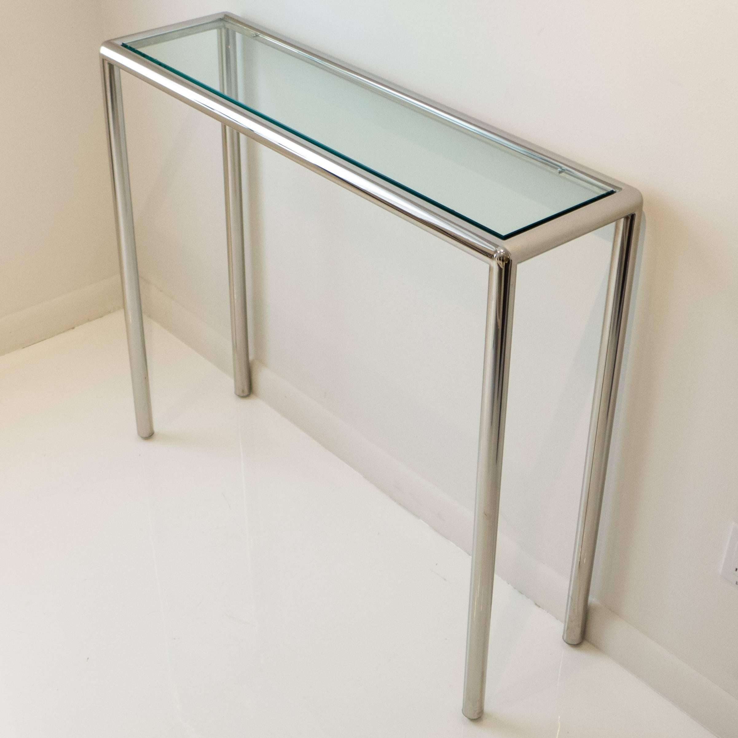 Tubular chrome-plated steel console table with glass top, in a custom tall, narrow size. In the style of and perhaps by John Mascheroni, circa 1970. The unusual conformation could work in an entryway, under an artwork, or as a small server. With