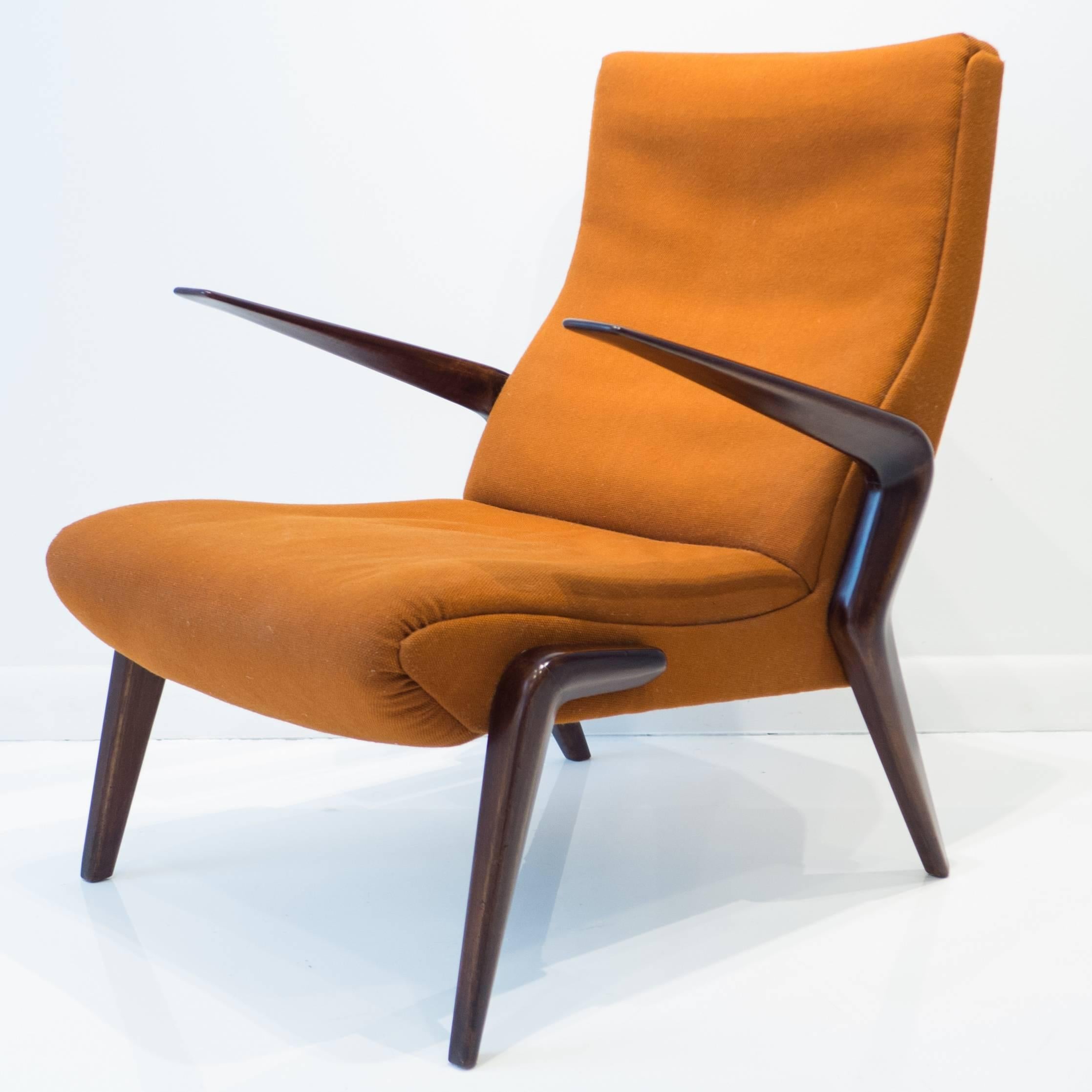 Lounge chair, model P71, designed by Osvaldo Borsani in 1954, and produced by his company, Tecno, circa 1950s. The sinuous carved walnut frame has been refinished; the fabric is original. A desirable and increasingly hard-to-find midcentury design