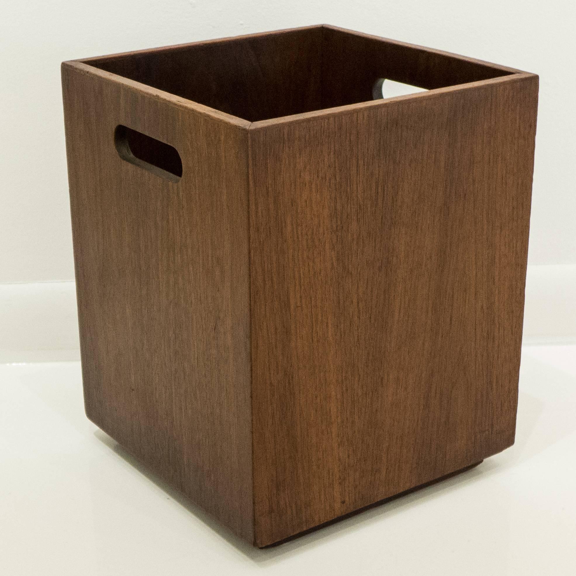 Square wastebasket with plinth base and oval cut-out handles, in walnut. Designed and made by Jens Risom, circa 1960s.
