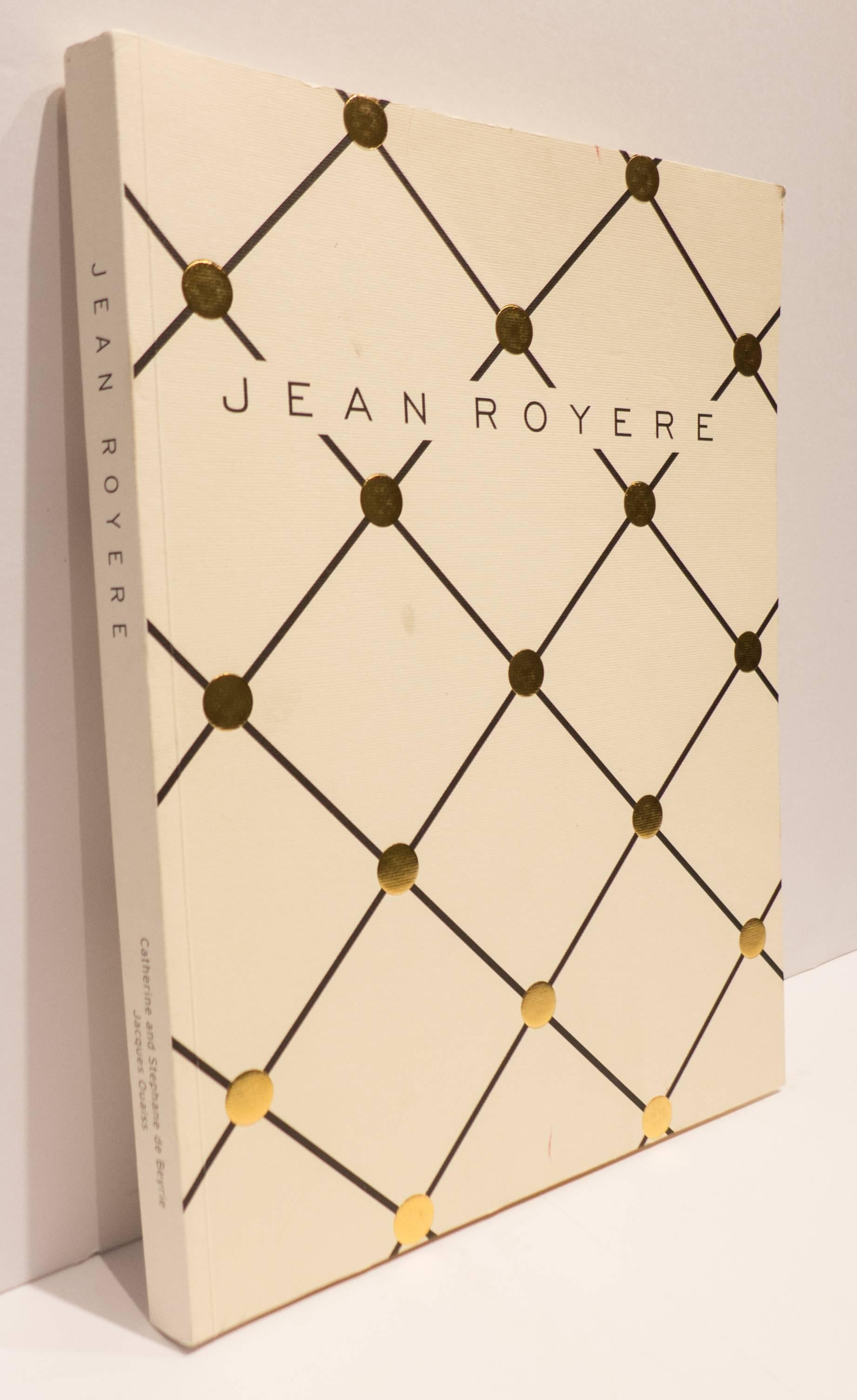 Scarce soft cover book, in English, showcasing the work of renowned French designer Jean Royere. 144 pages, many with full-color illustrations of Royere works divided into four sections: Metalwork; Sculptural furniture; Upholstered seating; and wood