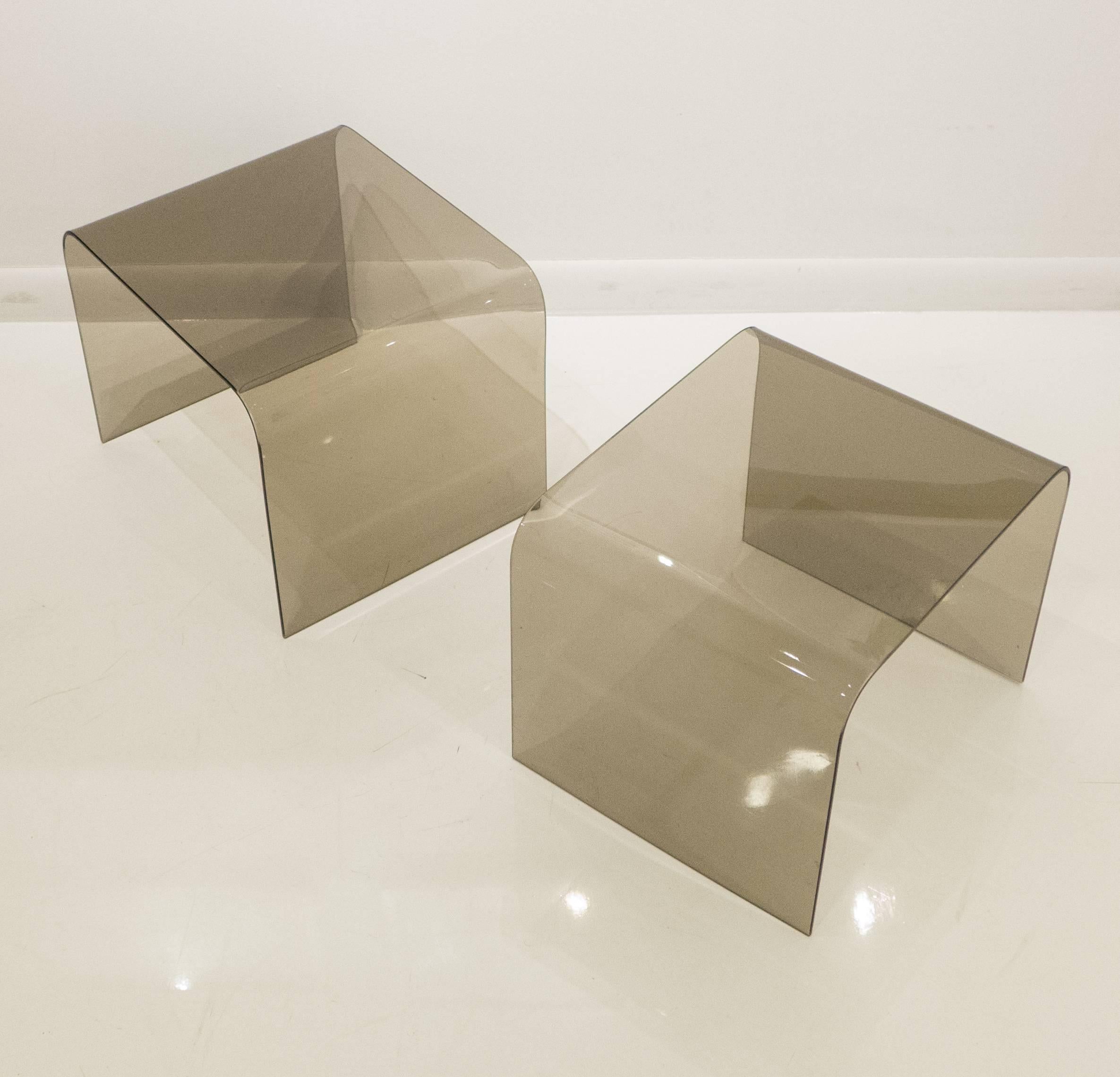 Pair of inverted u-shaped side tables of tempered smoked glass with polished edges. An elegant and well-made minimalist design. Purchased from the Pace Collection in New York City, circa 1972.