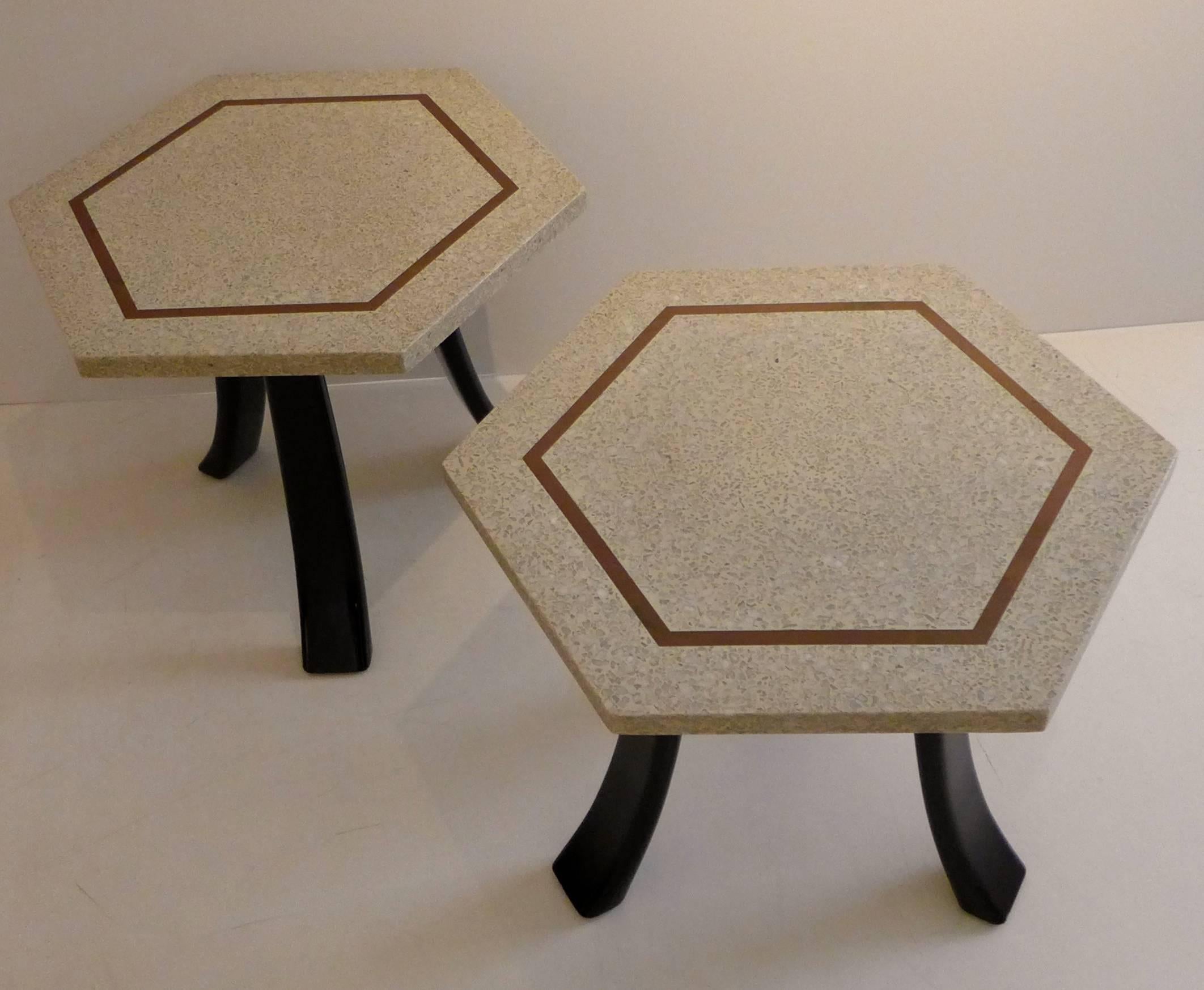 Pair of side tables designed and produced by Harvey Probber, with hexagonal terrazzo marble tops inlaid with brass, and splayed solid mahogany legs.  Can be used as side tables, small coffee tables, or can be pushed together to make a larger