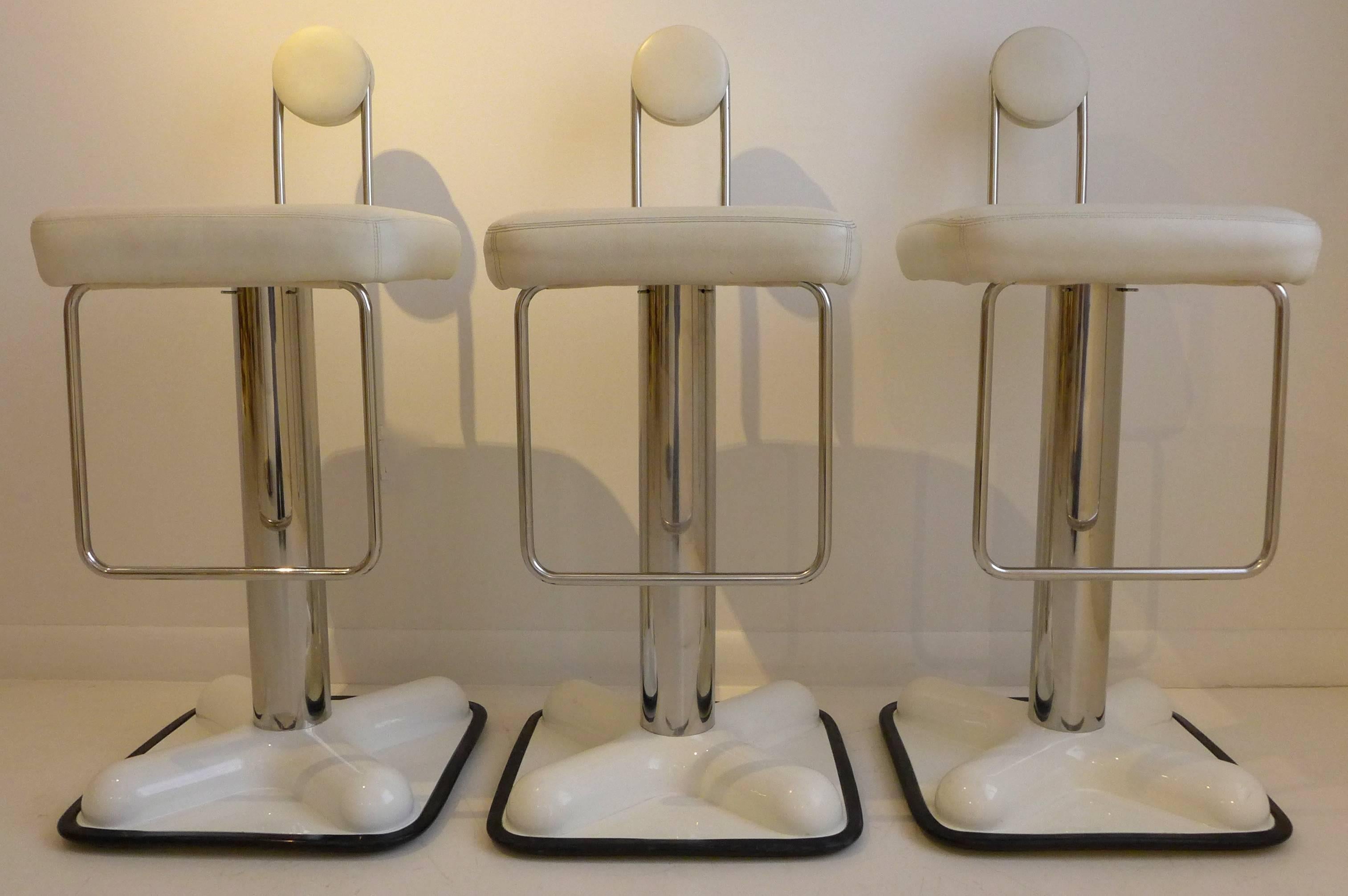 Set of three swivel bar stools, of chrome, leather and lacquered plastic, designed by Joe Colombo in 1971 and produced by Zanotta at a later date. In excellent condition, with only minor wear consistent with age and use. With Zanotta label and