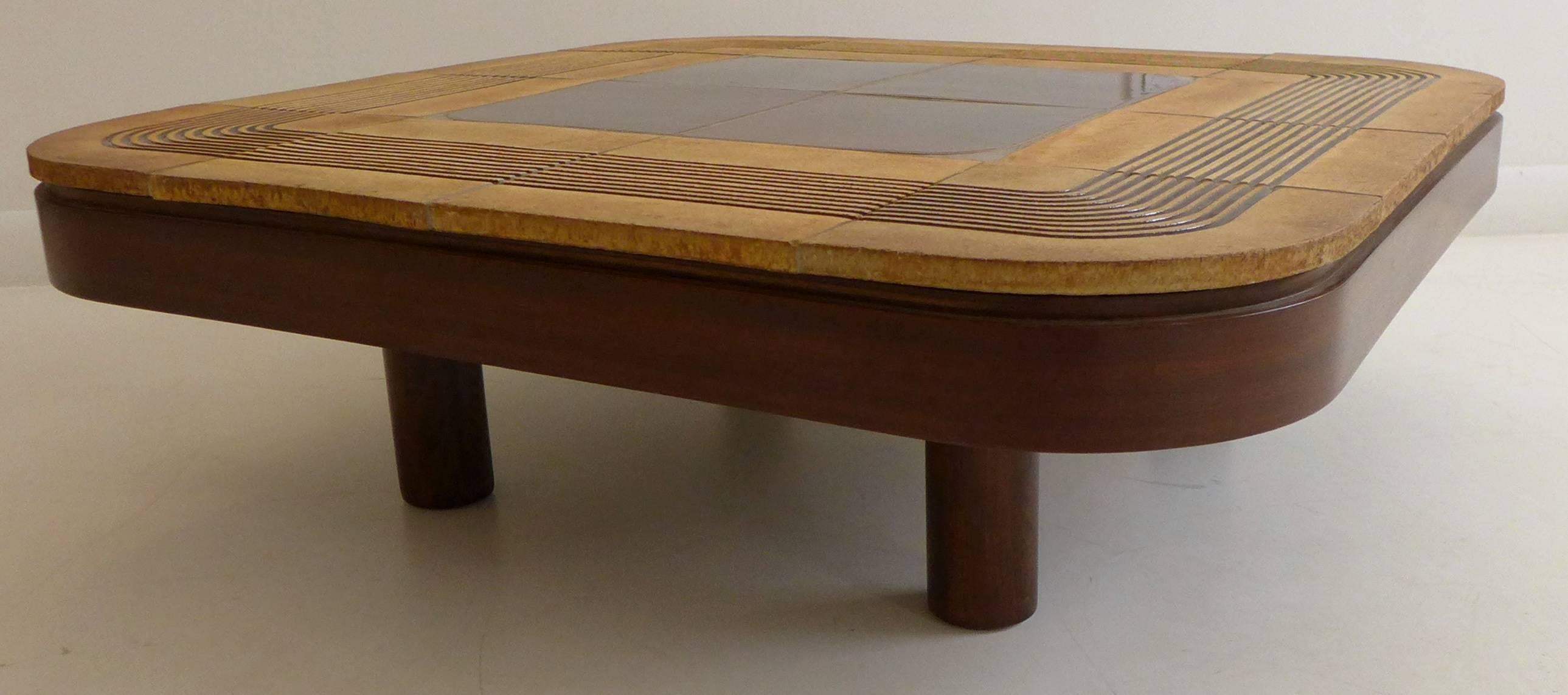 Ceramic tile cocktail table with rounded edges, in wooden frame, by French artist/designer Roger Capron. Executed, circa 1970s. The tiles combine glazed and unglazed surfaces. In excellent original condition.