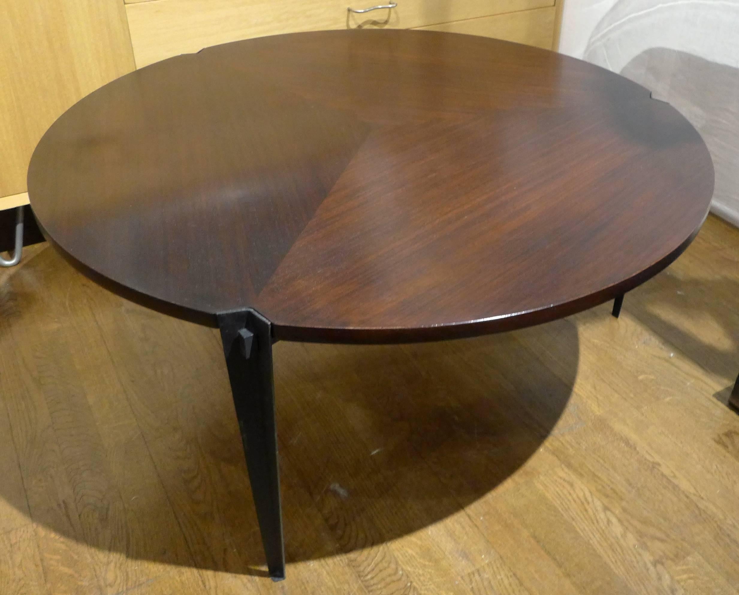 Round cocktail table with tripod enameled steel base. Top is reversible; rosewood on one side, mahogany on the other-both sides with pie-shaped patterning. Designed by Osvaldo Borsani for Tecno, circa 1960. Elegant details throughout. Top has been