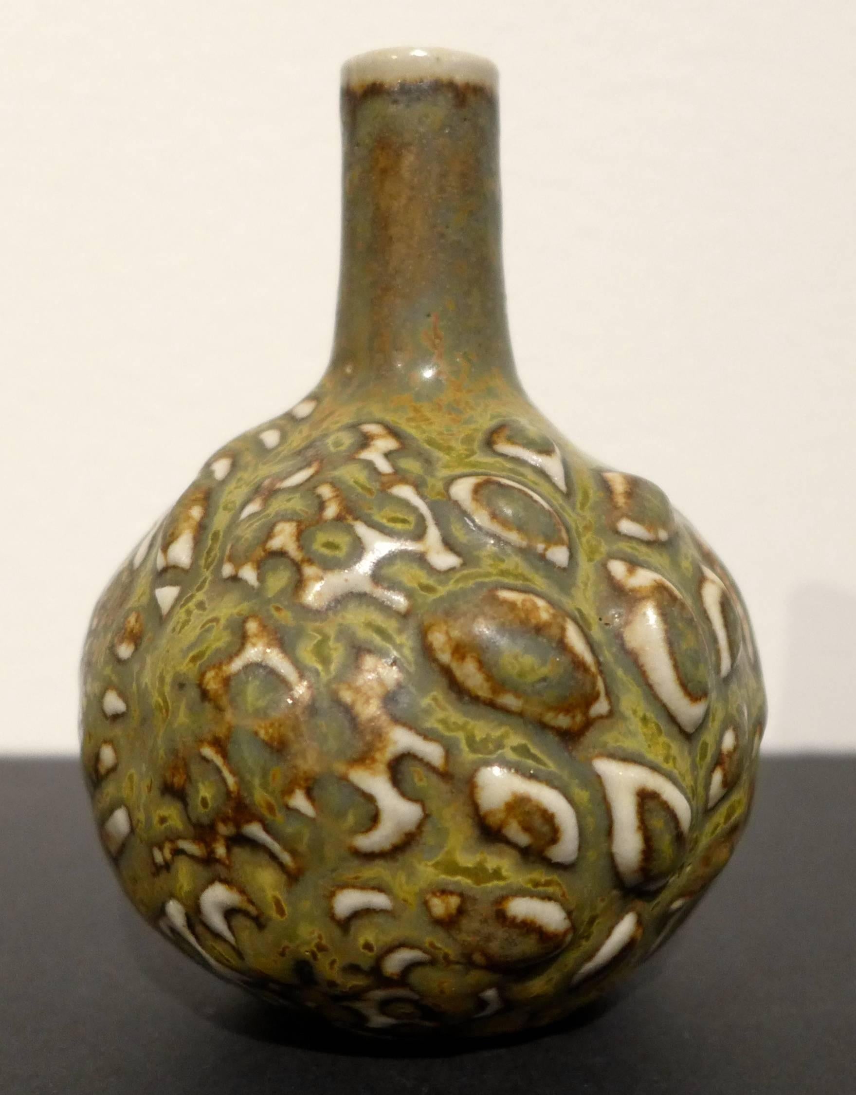 Small budding vase with greenish/yellow to brown solfatara glaze, by Danish master ceramist Axel Salto. Produced at Royal Copenhagen, circa 1950s. Etched Salto signature, along with painted waves and the number 21423.