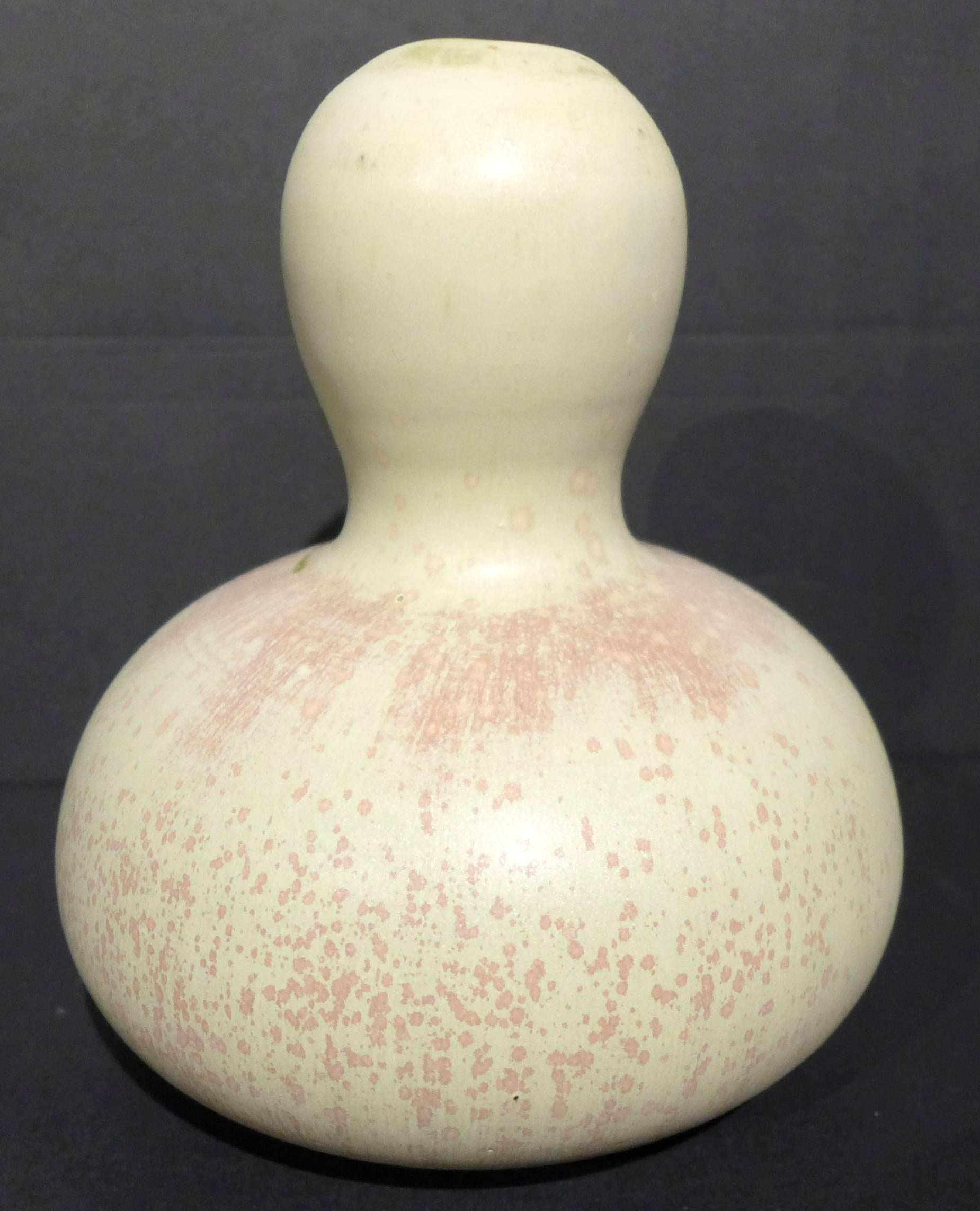 Gourd-shaped stoneware vessel with an unusual buff and brick pink glaze, by eminent Danish ceramic artist Axel Salto. Produced at Royal Copenhagen, circa 1950. In excellent original condition. Etched signature and painted waves on bottom.