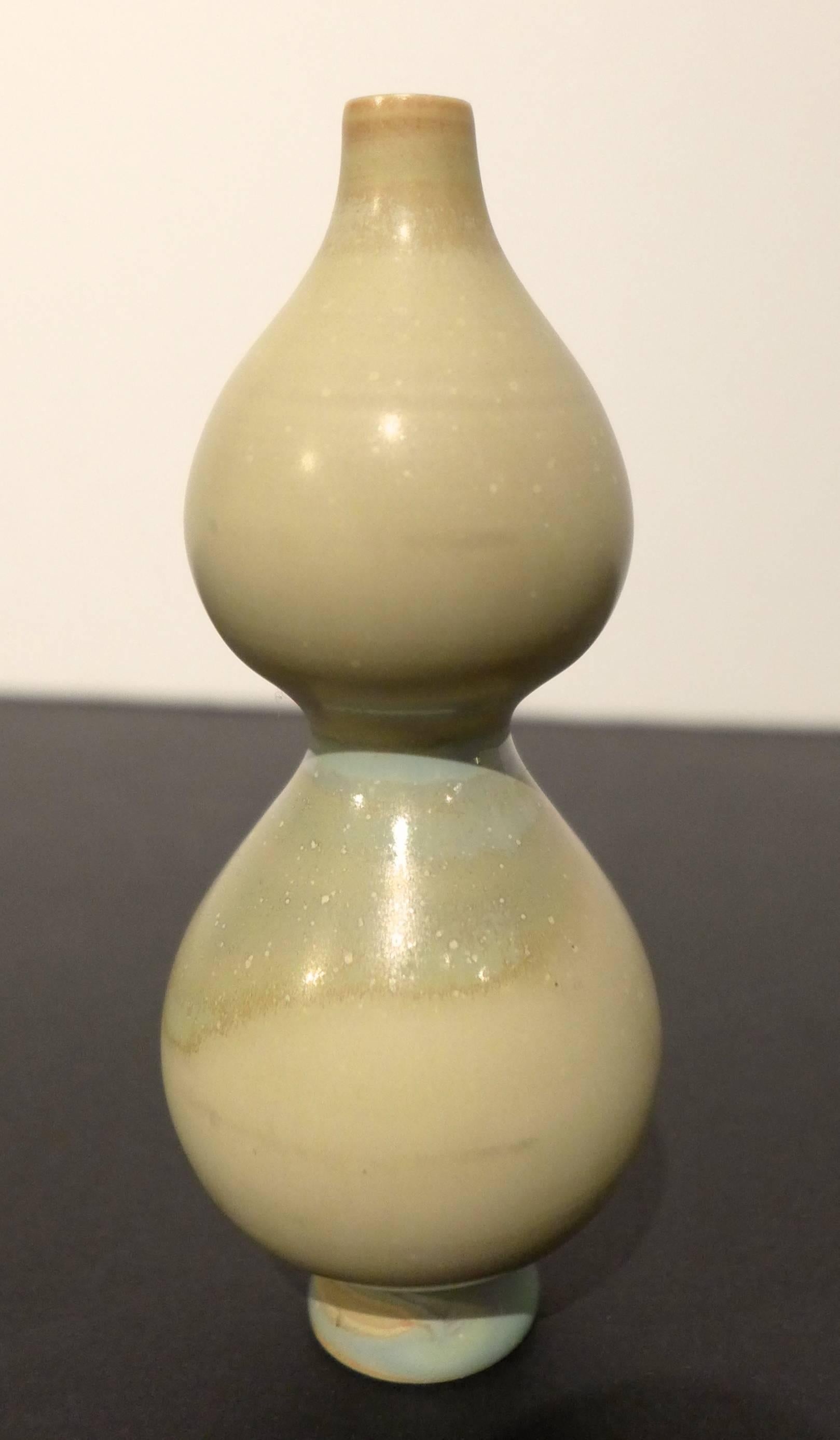 Small gourd-shaped vase with footed base and narrow spout, with multi-chromatic glaze. Made by Swedish ceramist and designer Stig Lindberg at Gustavsberg, circa 1960s. Incised marks to bottom.