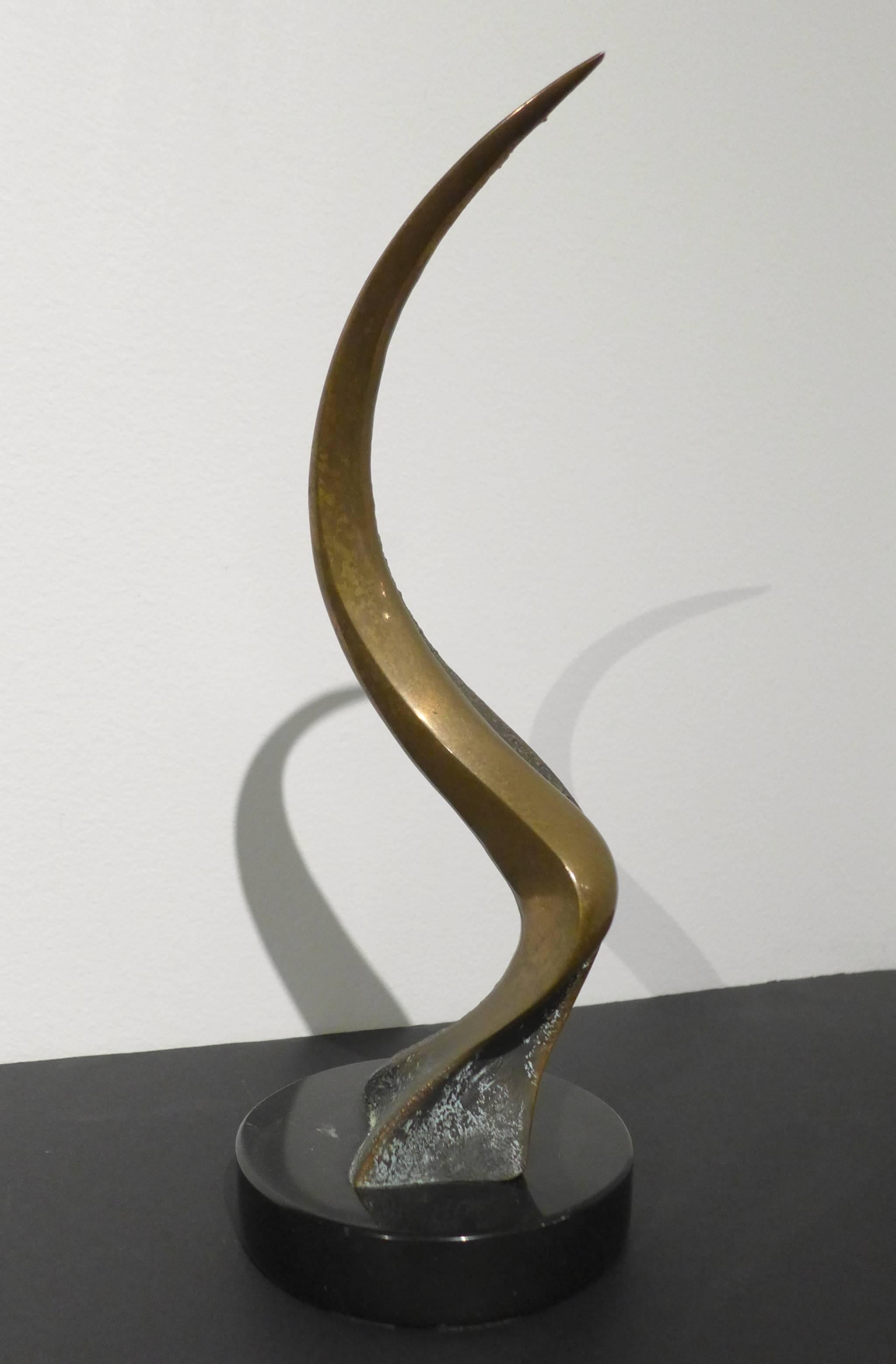 Cast bronze abstract sculpture on a polished marble base by Carmel, CA artist Tom Bennett. The polished bronze typical of the Bennett Brothers work is contrasted here with a textured and patinated section. Identical twins Tom and Bob Bennett