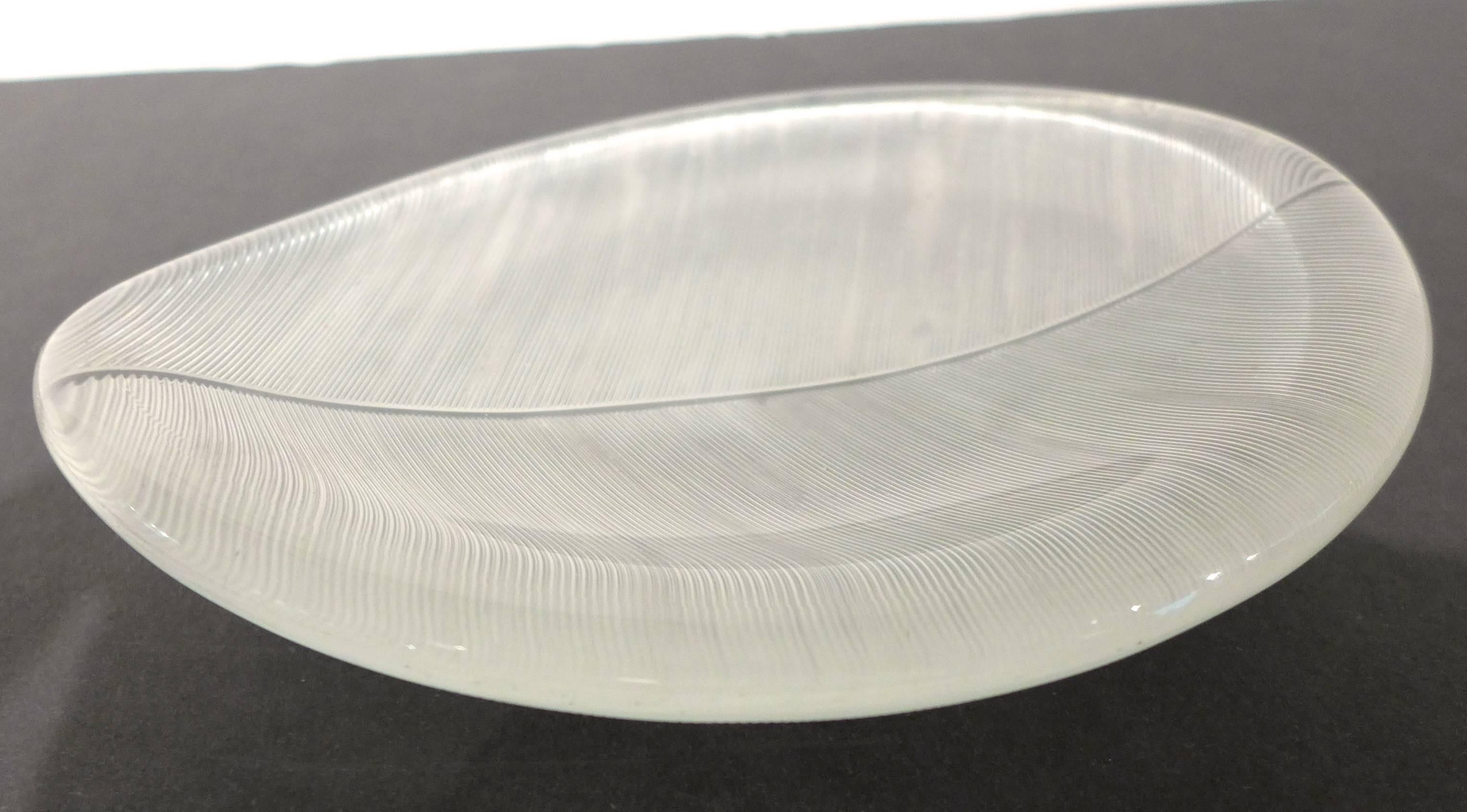 Line-cut and mold-formed glass dish designed by Tapio Wirkkala and produced by Iittala, circa 1955. A nice example of his iconic leaf patterning in glass, fully signed on the side.